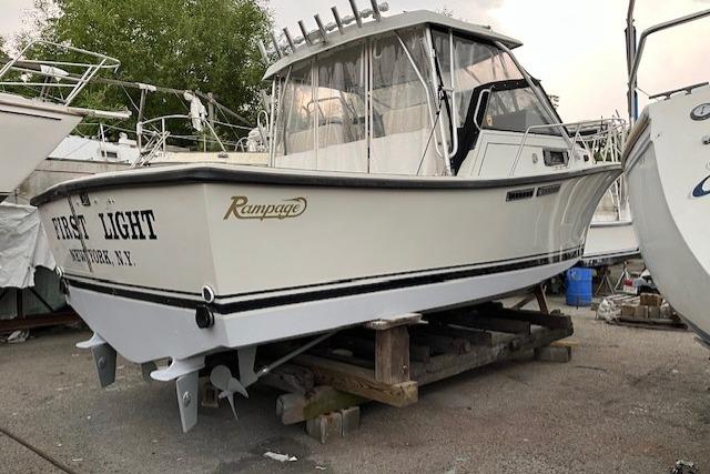 1989 Rampage 28 Sportsman boat on dry dock, labeled "First Light," Newburgh, N.Y.