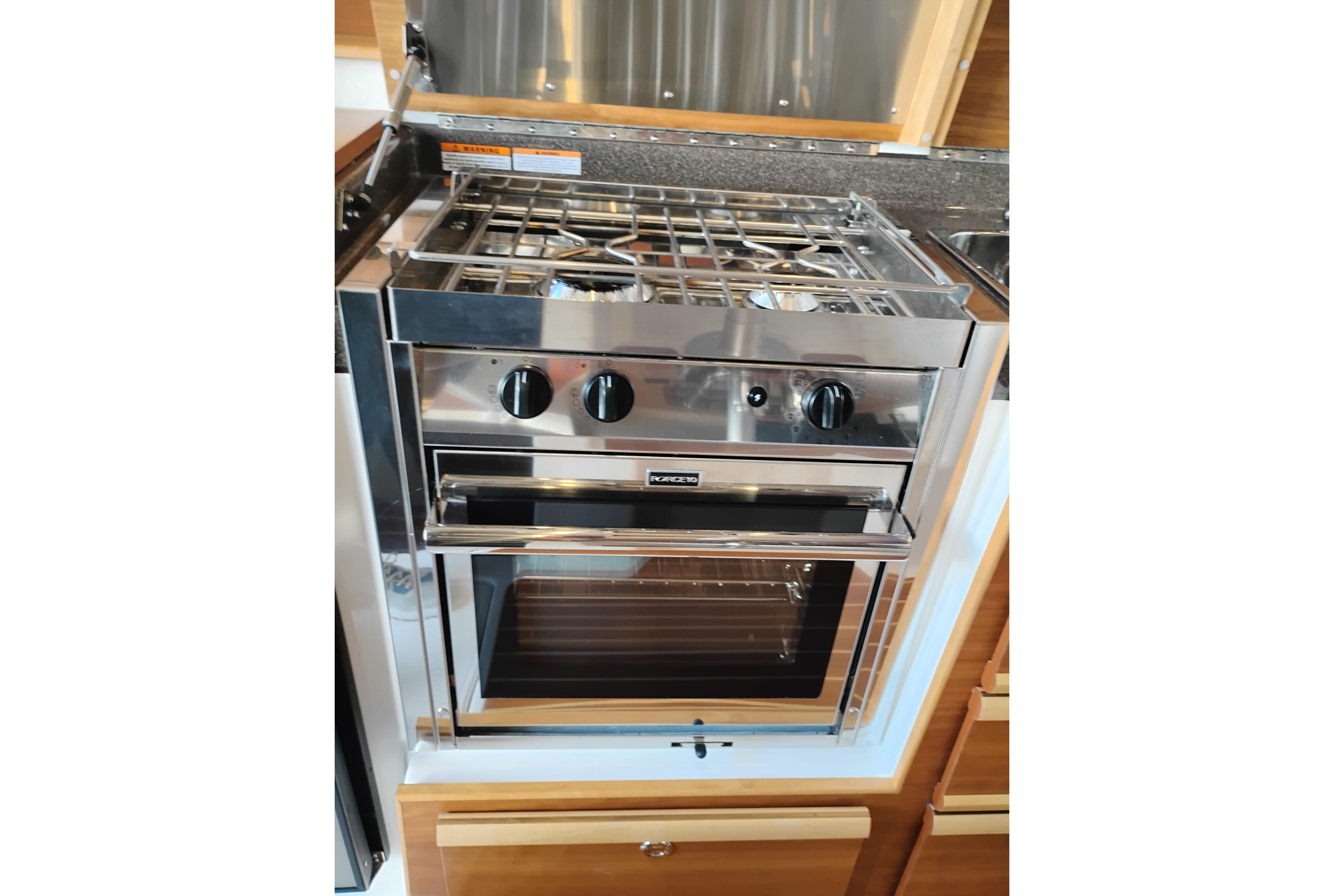 Stainless steel stove and oven in 2022 Cutwater C-32 Coupe yacht kitchen.