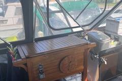 1988 Chris-Craft 381 Catalina interior with wooden cabinetry and nautical decor.