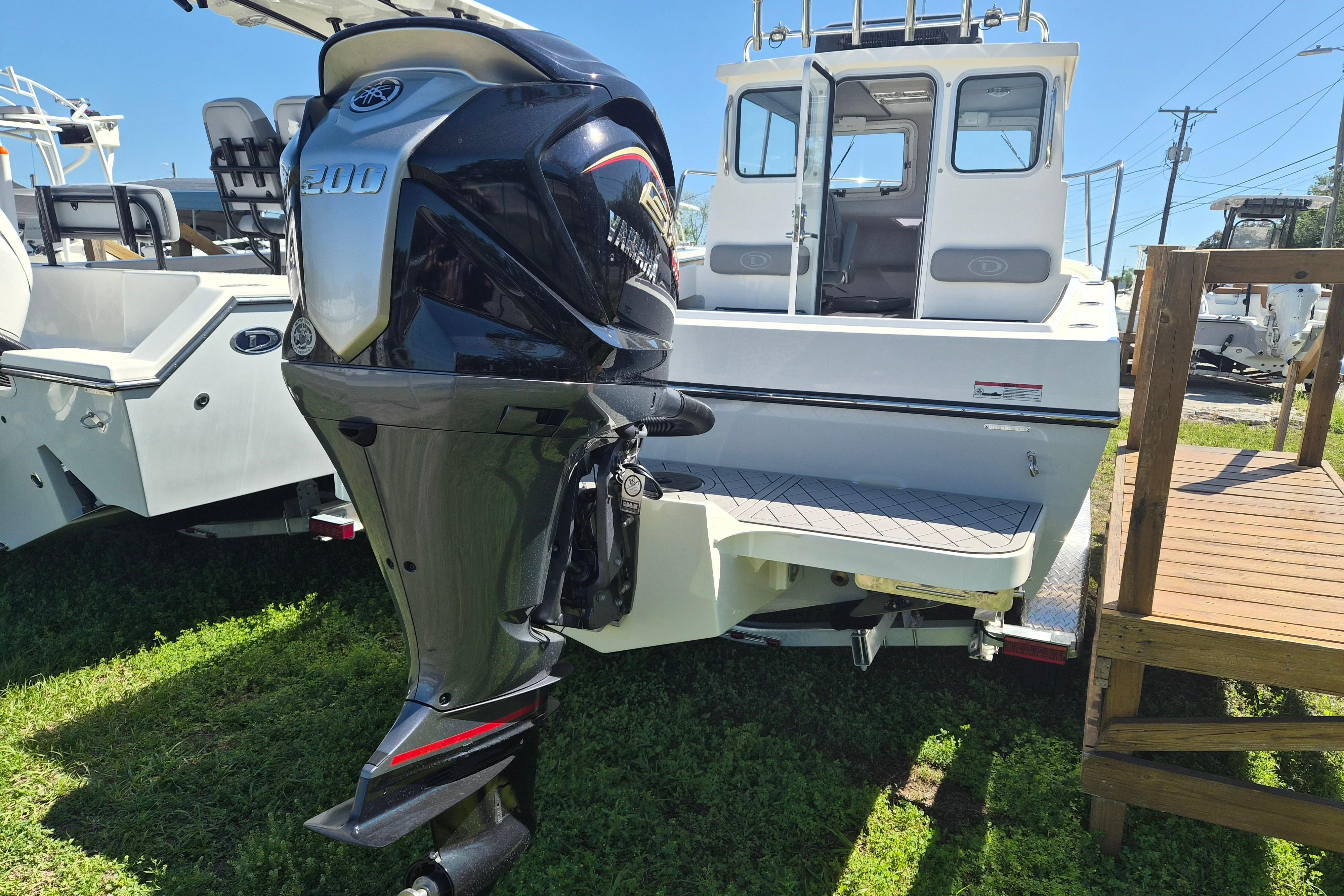 2026 Defiance Admiral 220 EX boat with Yamaha 200 outboard motor, displayed outdoors.
