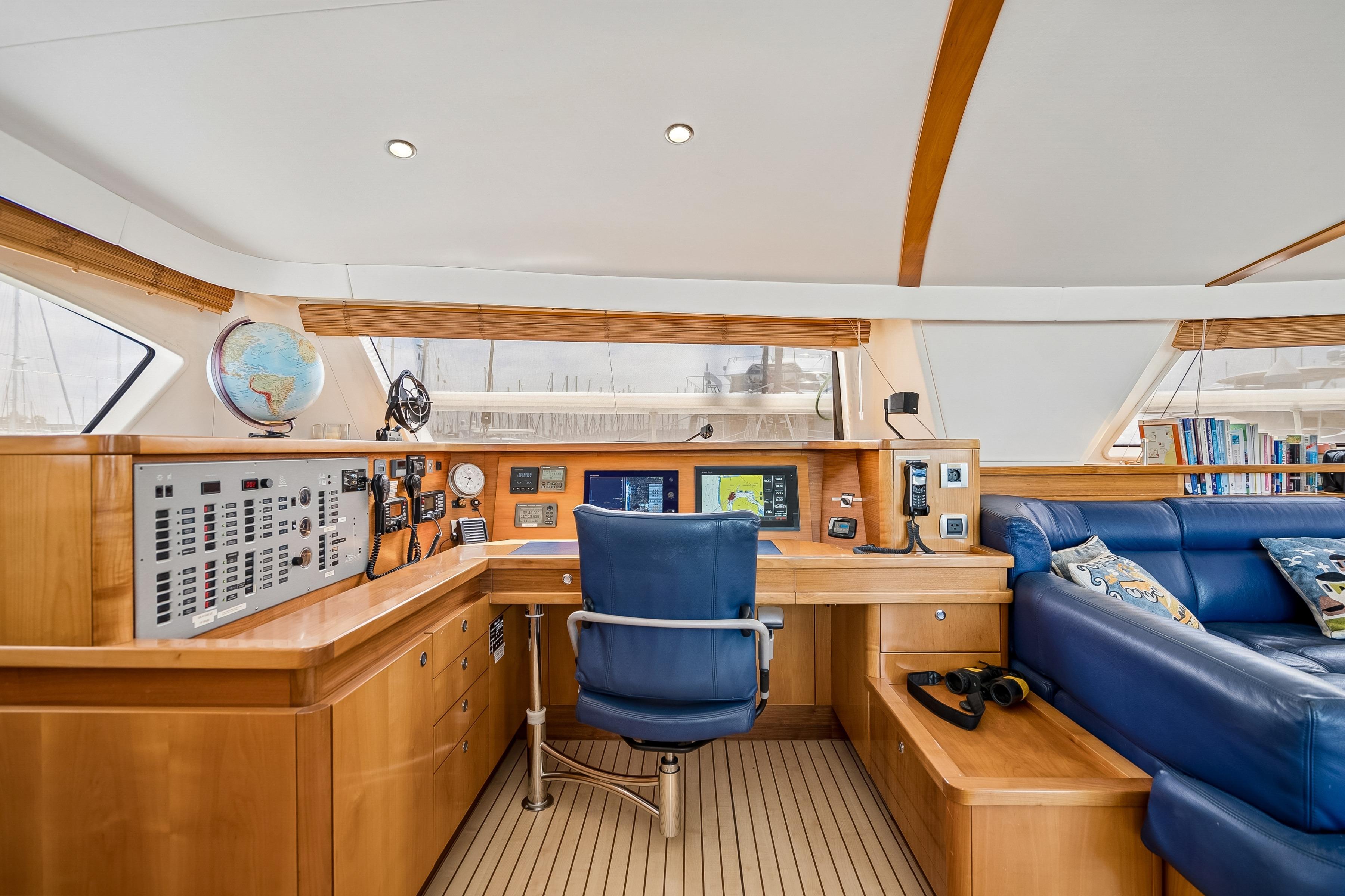 Luxurious 2009 Catana 65 yacht interior with navigation station and plush seating.
