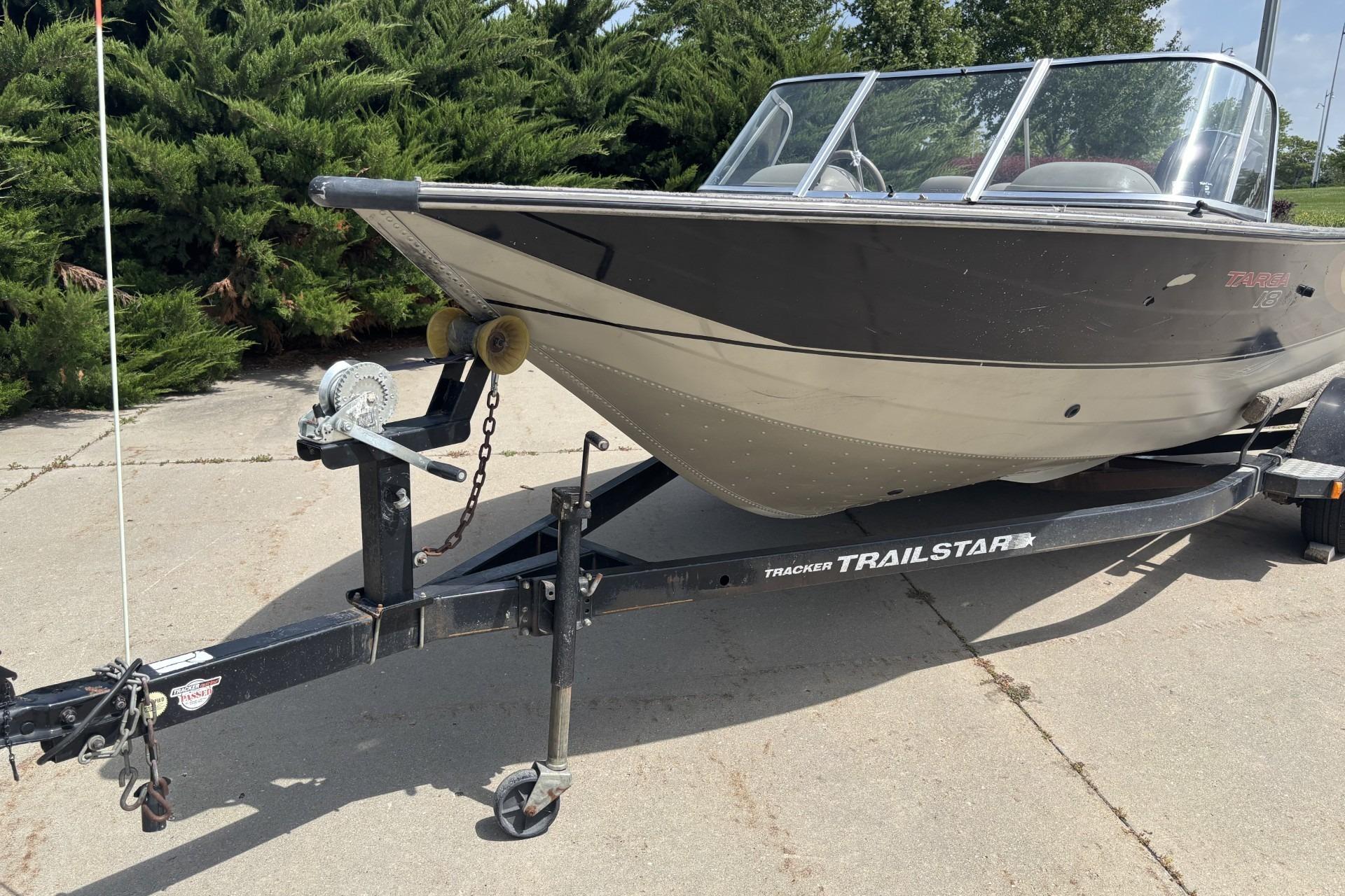 1999 Tracker Targa 18 boat on a Trailstar trailer, parked on concrete.