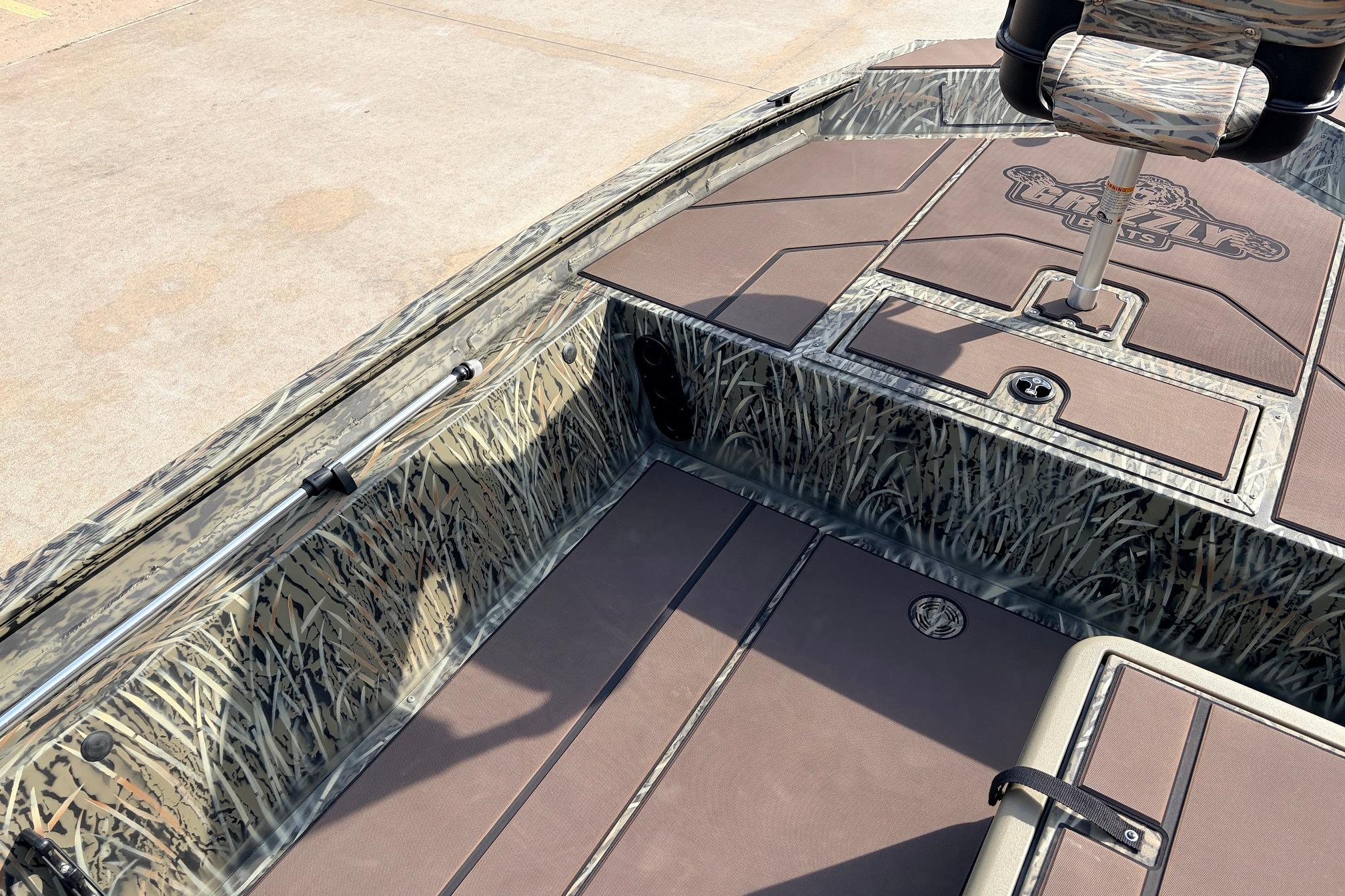 2026 Tracker Grizzly 1754 SC boat interior with camo design and seating.