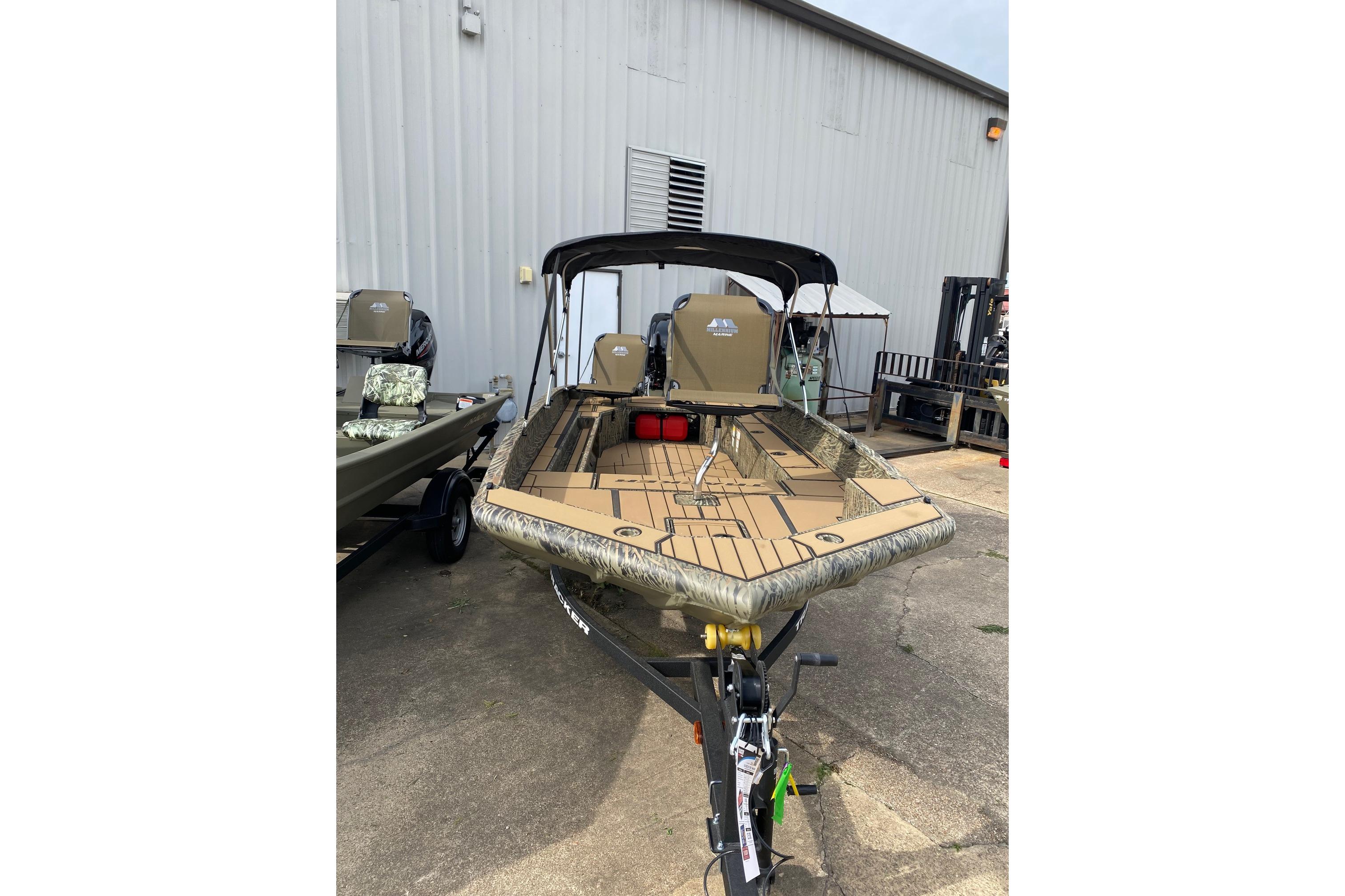 2026 Tracker Grizzly 1756 T Marsh boat with camouflage design, parked outdoors.