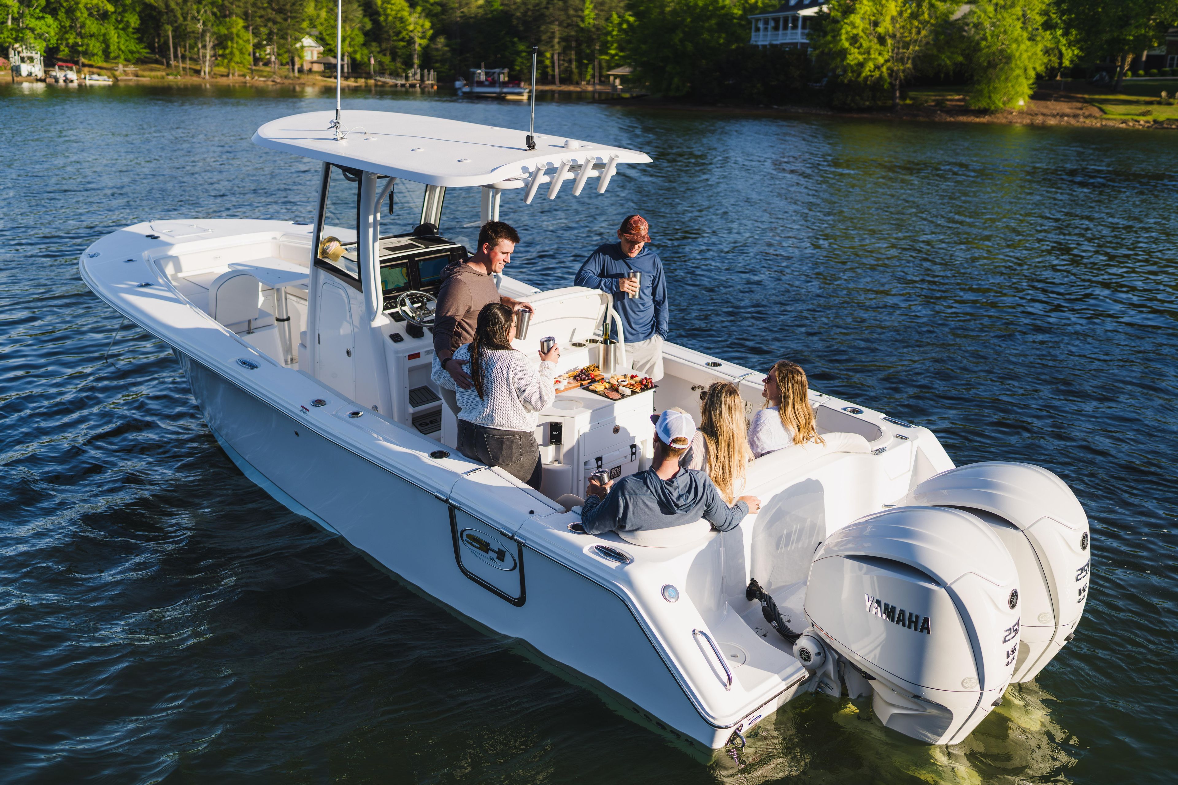 2027 Sea Hunt Ultra 275 SE boat with people enjoying a sunny day on the water.