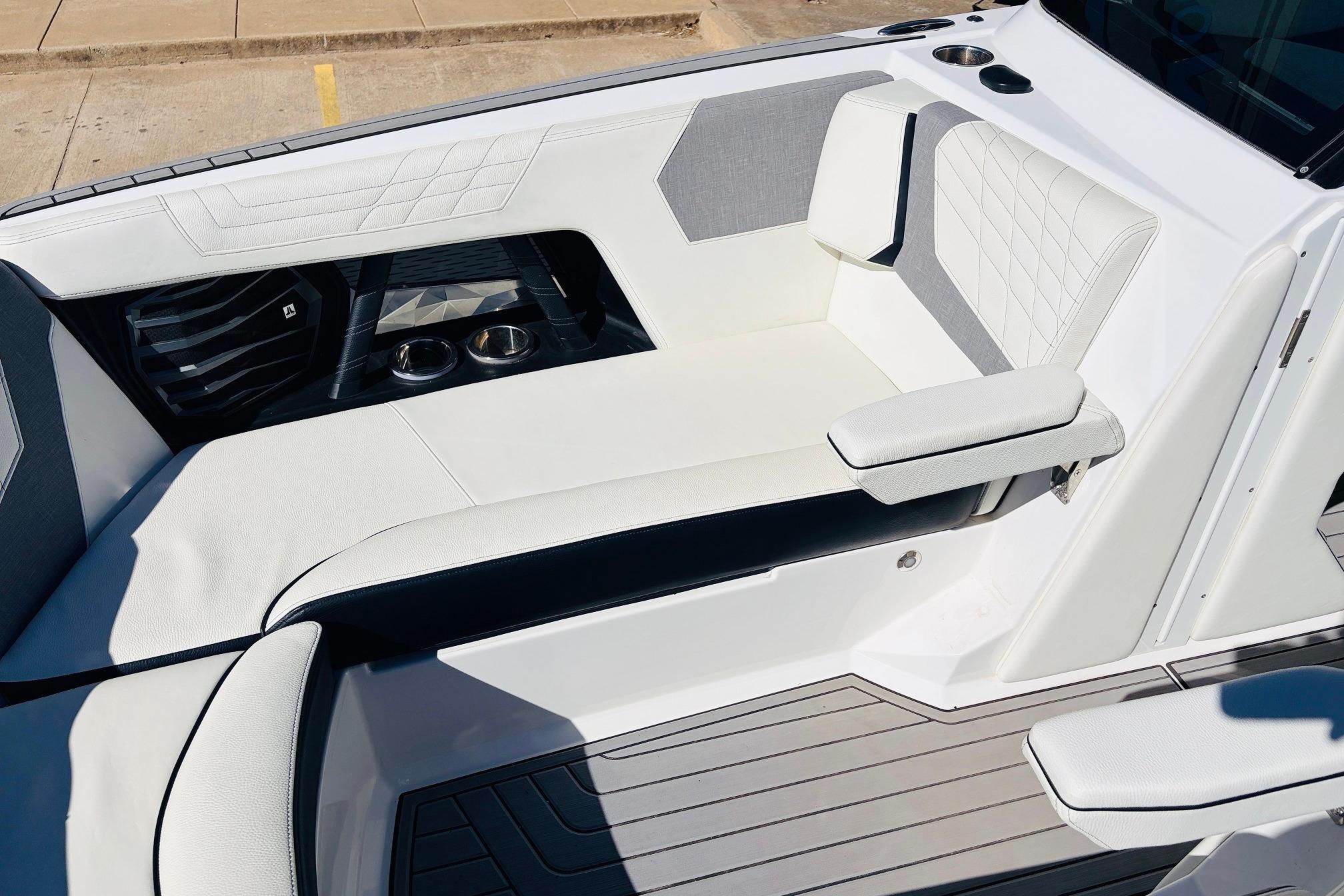 2023 Nautique Super Air Nautique G25 interior with white seating and cup holders.