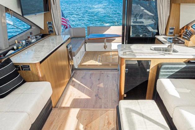 Luxurious interior of 2017 Sea Ray 460 Sundancer yacht with high quality  seating and ocean view.