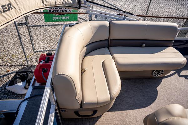 2025 Sun Tracker Bass Buggy 16 DLX pontoon boat with beige seating and storage.