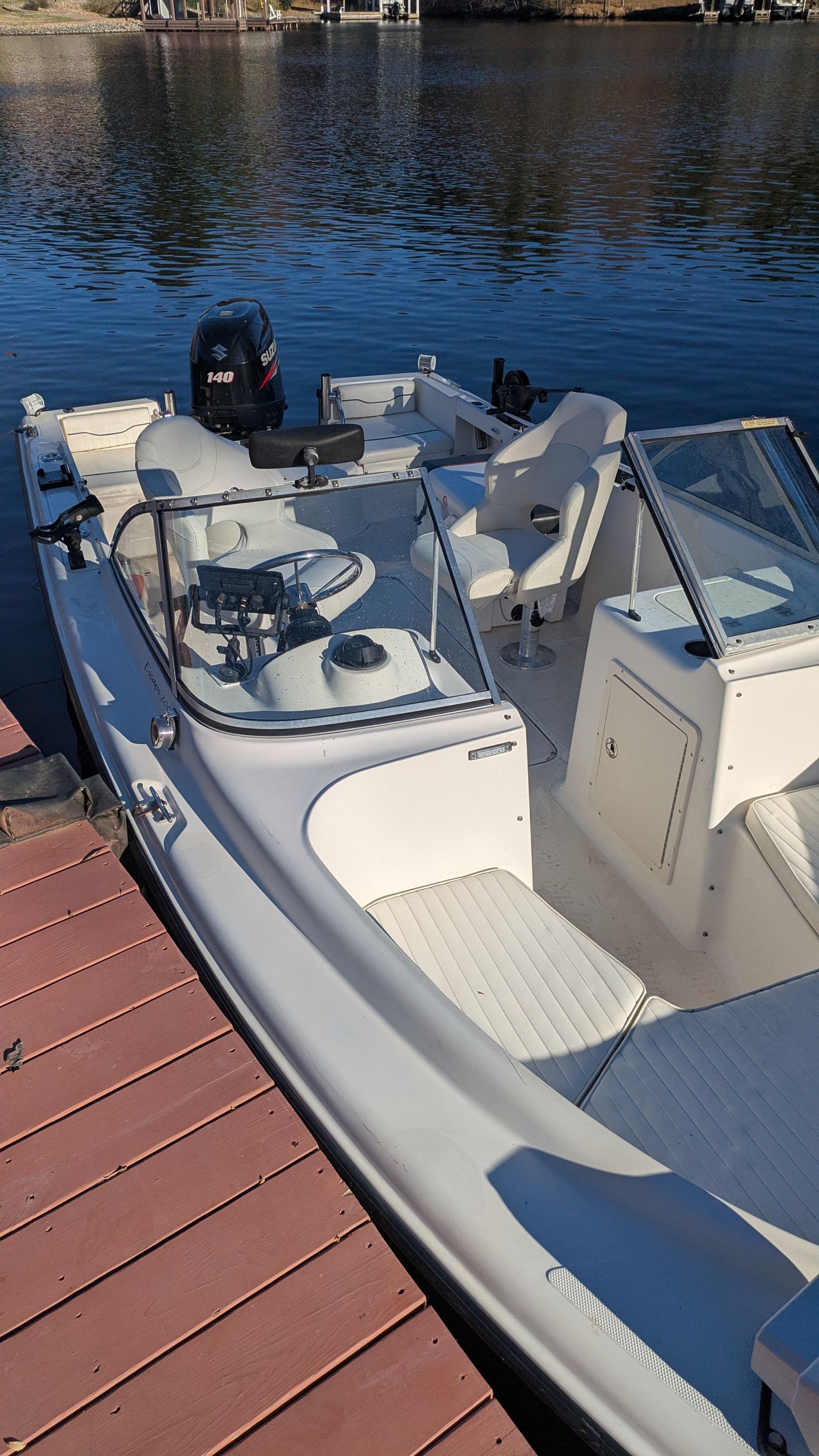 2000 Sea Hunt Escape 200 boat docked by the water.