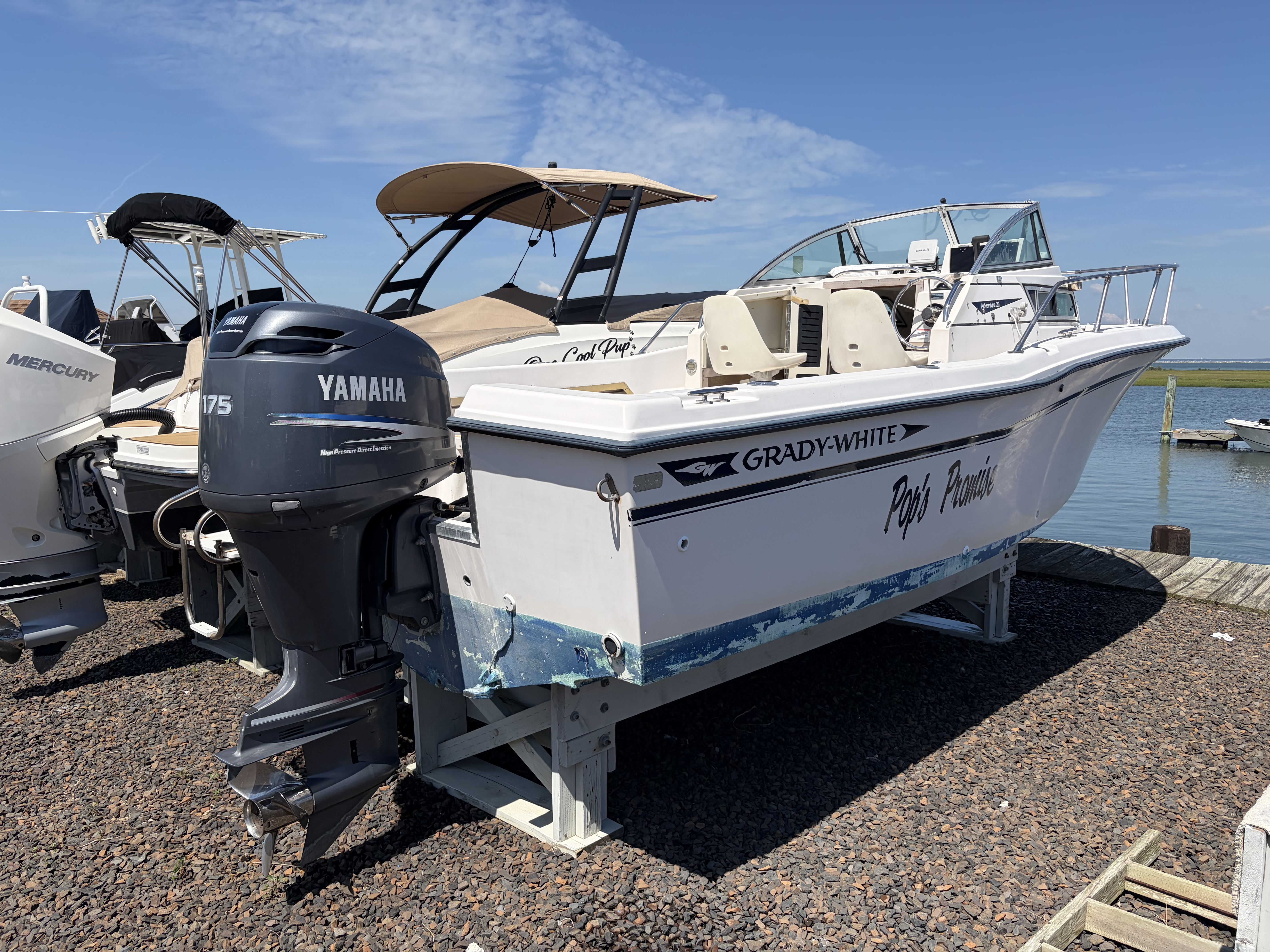 1993 Grady-White Adventure 208 on a boat stand by the shore.