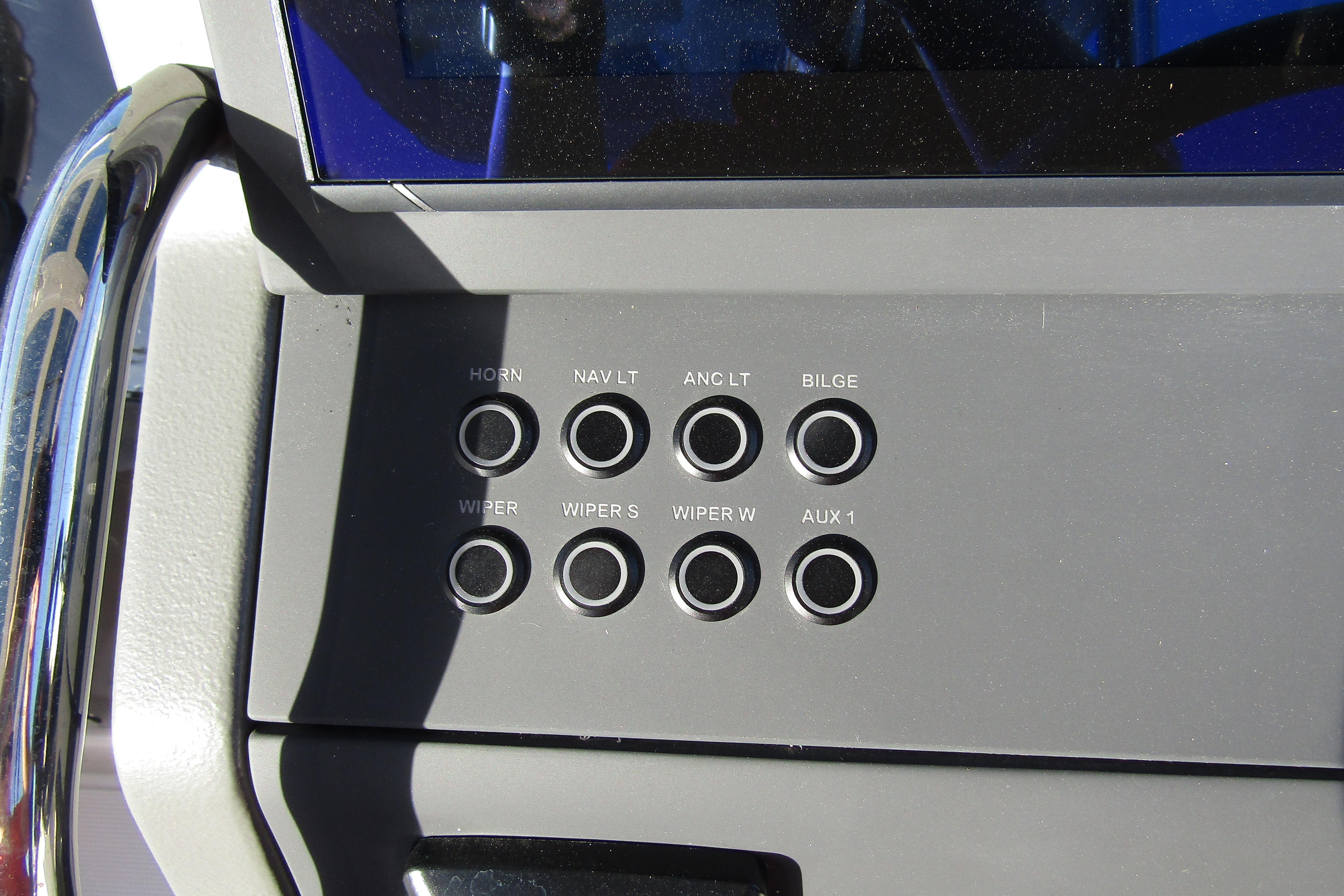 Control panel of 2025 Nimbus Tender 9 boat with labeled buttons.