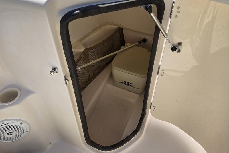 2007 Grady-White Tournament 205 boat storage compartment with portable toilet.