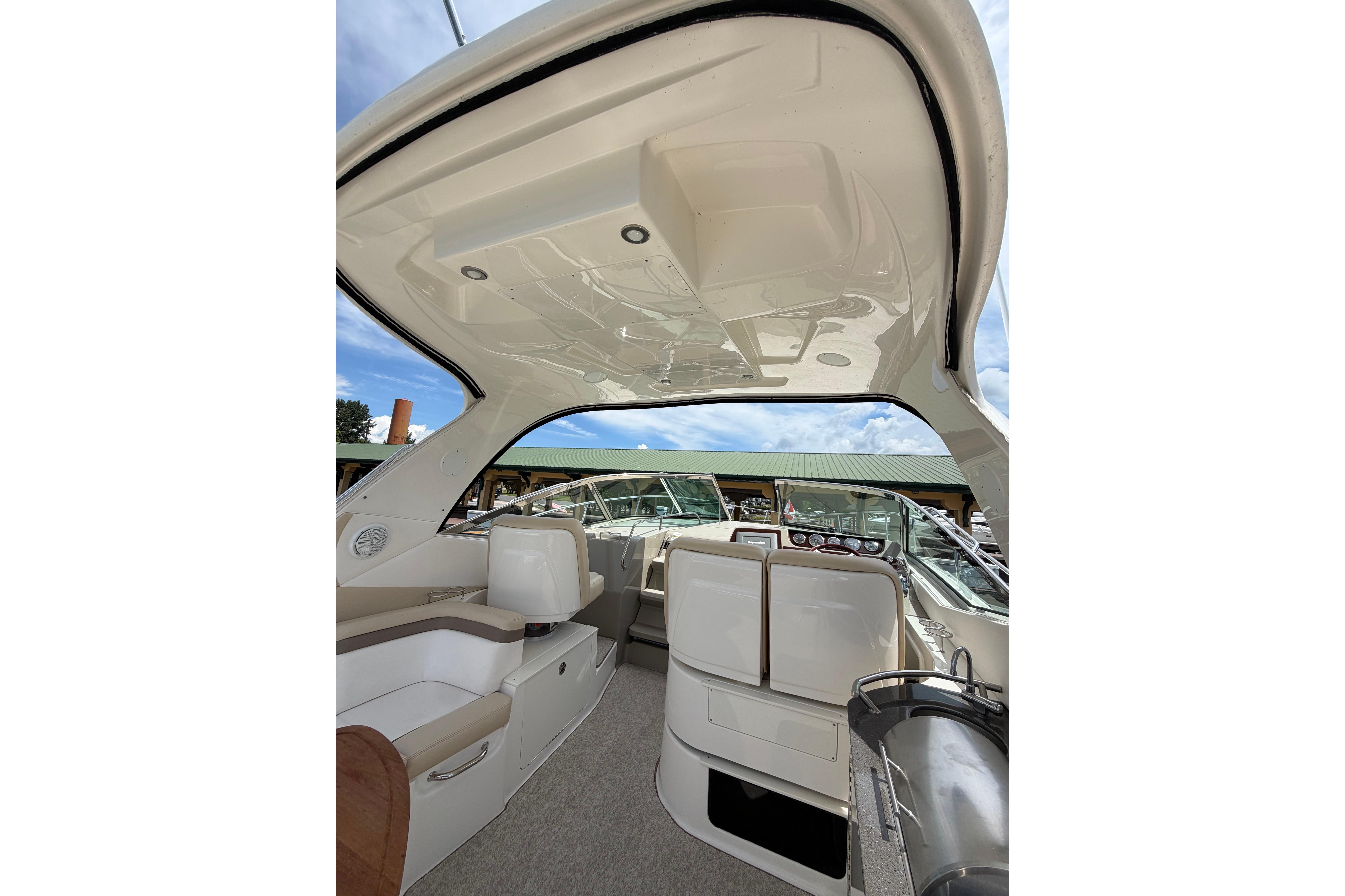 Interior view of 2012 Sea Ray Sundancer 370 yacht, showcasing seating and helm area.