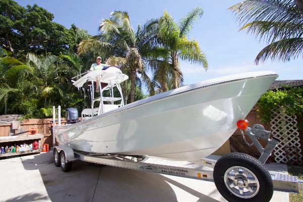 2011 Andros 26 Tarpon on a trailer, surrounded by palm trees.