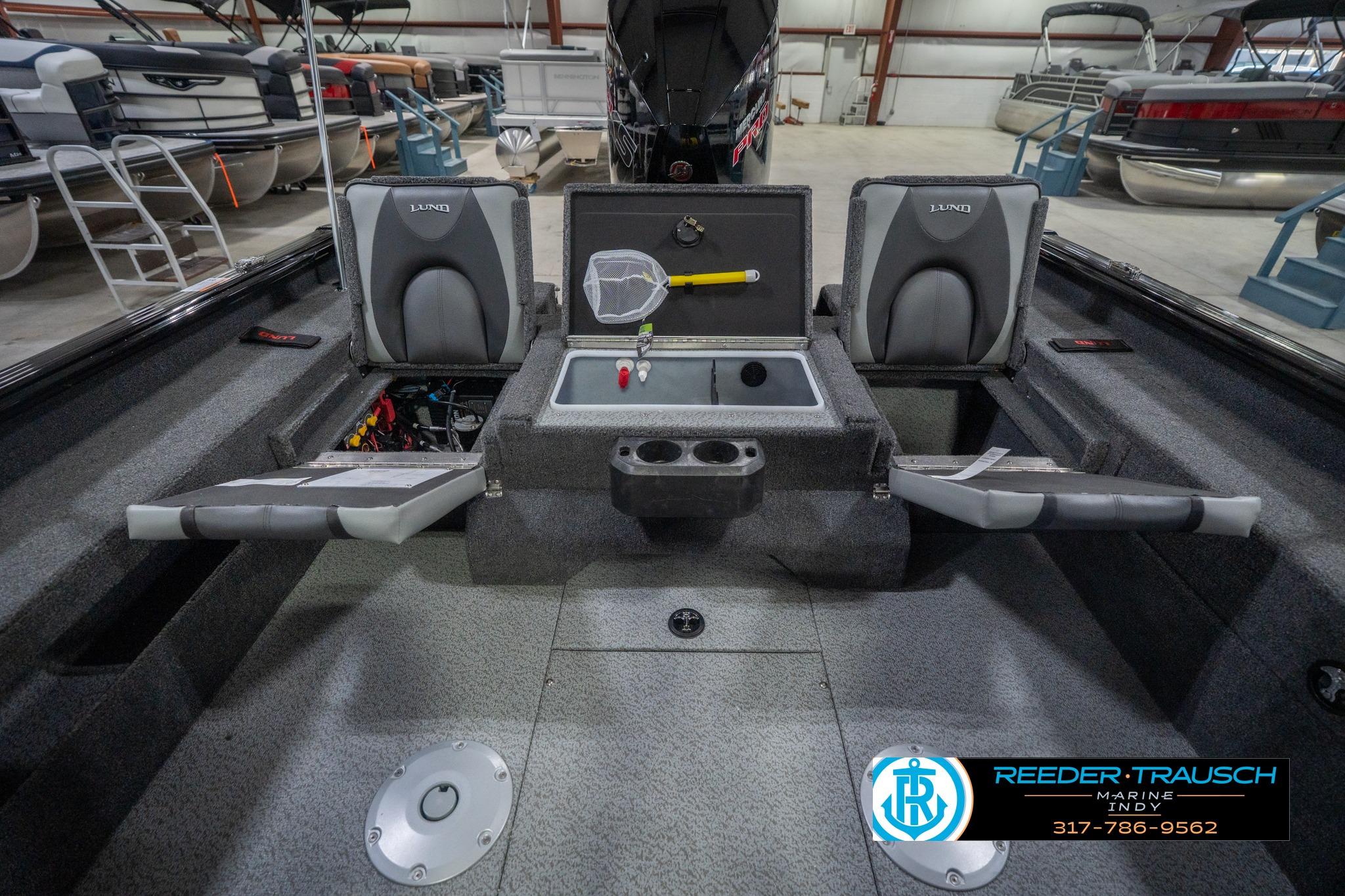2026 Lund 2075 Impact XS boat interior with seating and storage compartments.