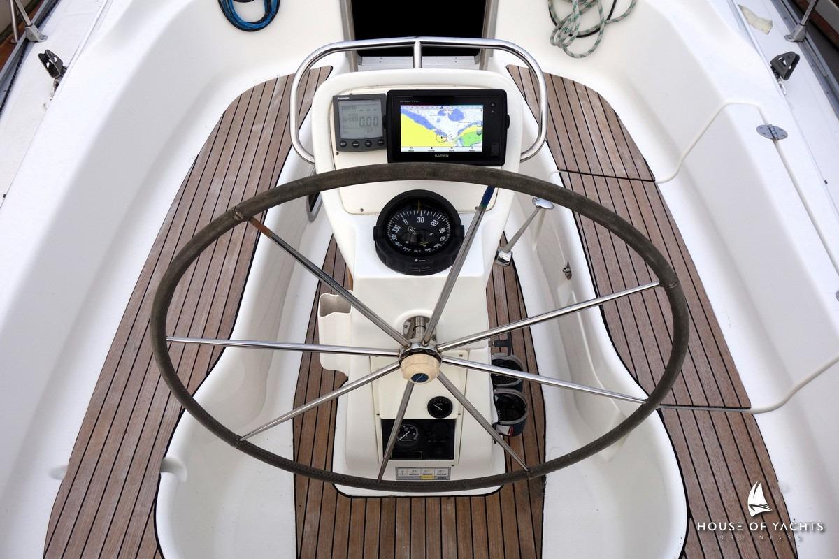 Steering wheel and navigation equipment on 2003 Bavaria 32 yacht deck.