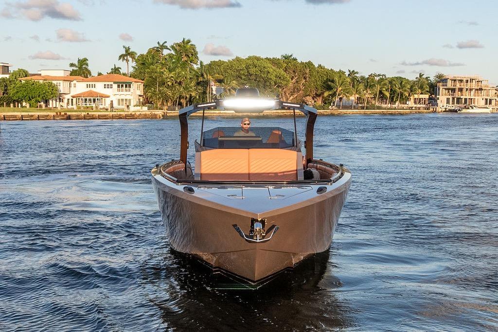 Luxury DeKoning 43 yacht cruising on a scenic waterway, 2023 model.
