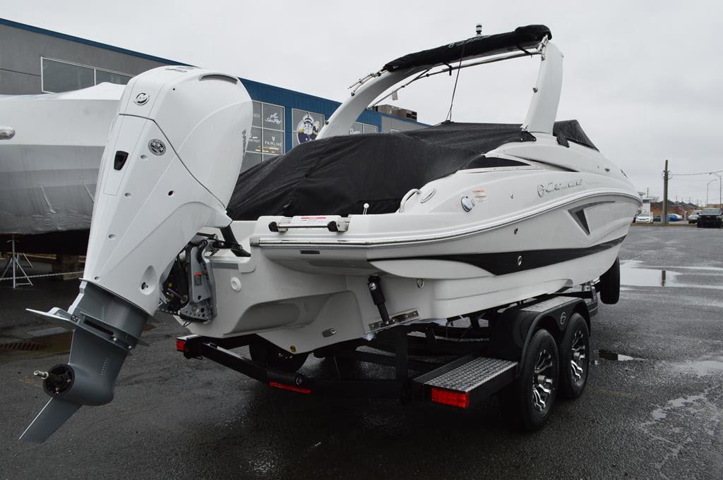 2024 Crownline Eclipse E260 XS boat on trailer, covered, with outboard motor.
