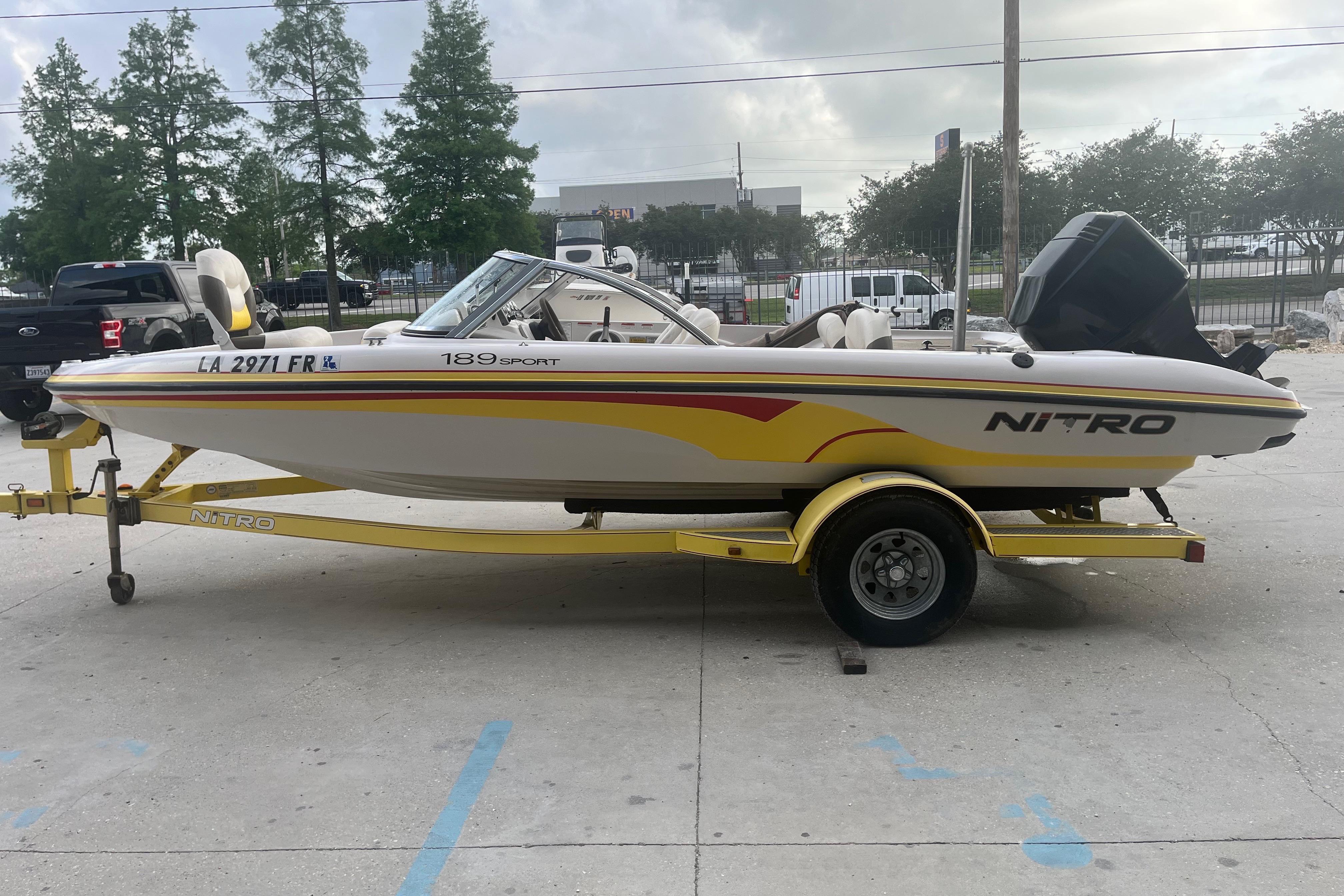 2006 Nitro 189 Sport boat on trailer, parked outdoors, side view.
