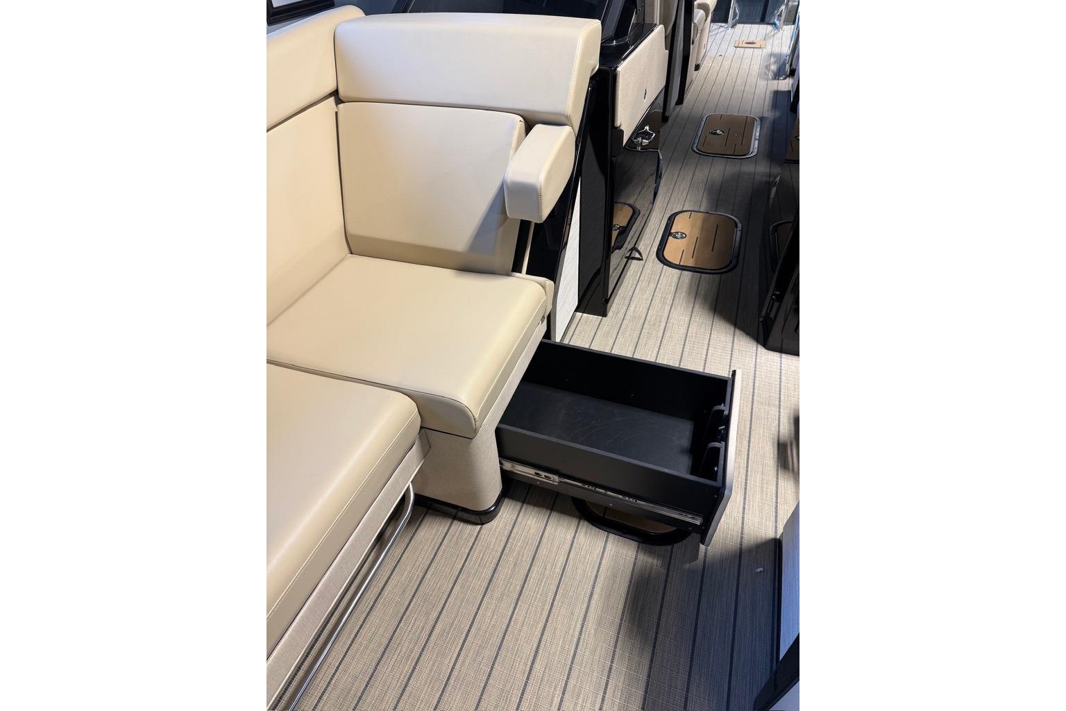 Interior of 2026 Balise Halo 26C Twin with beige seating and open storage drawer.