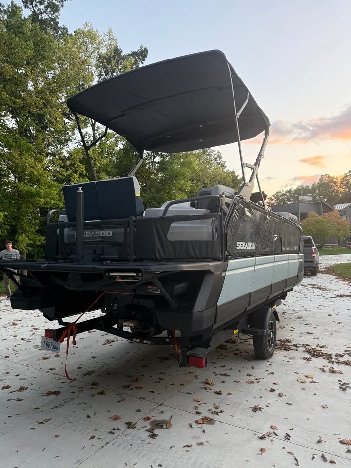 2025 Sea-Doo Switch Cruise Limited 21 on a trailer, surrounded by trees.