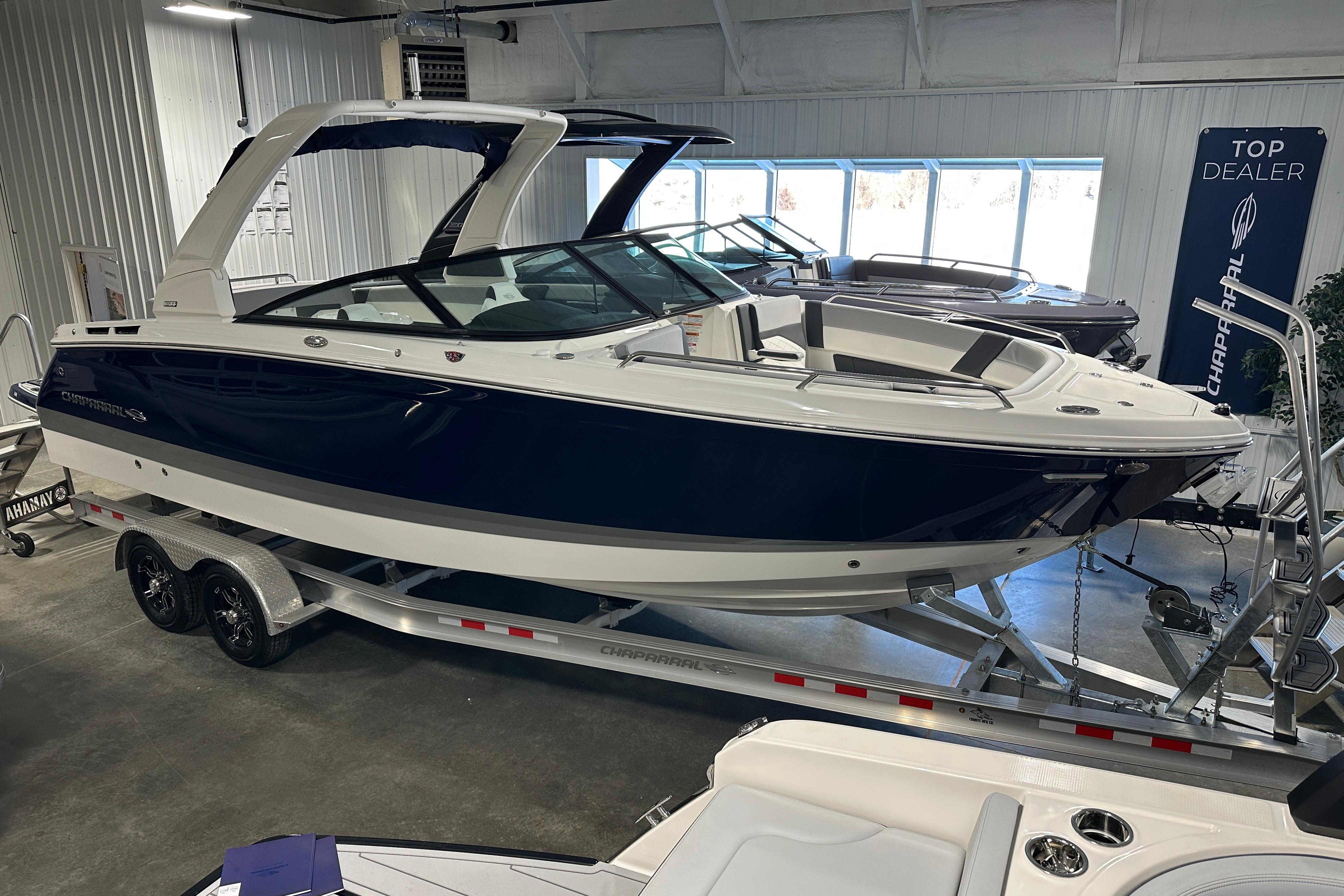 2026 Chaparral SSX 8 boat in showroom on trailer.
