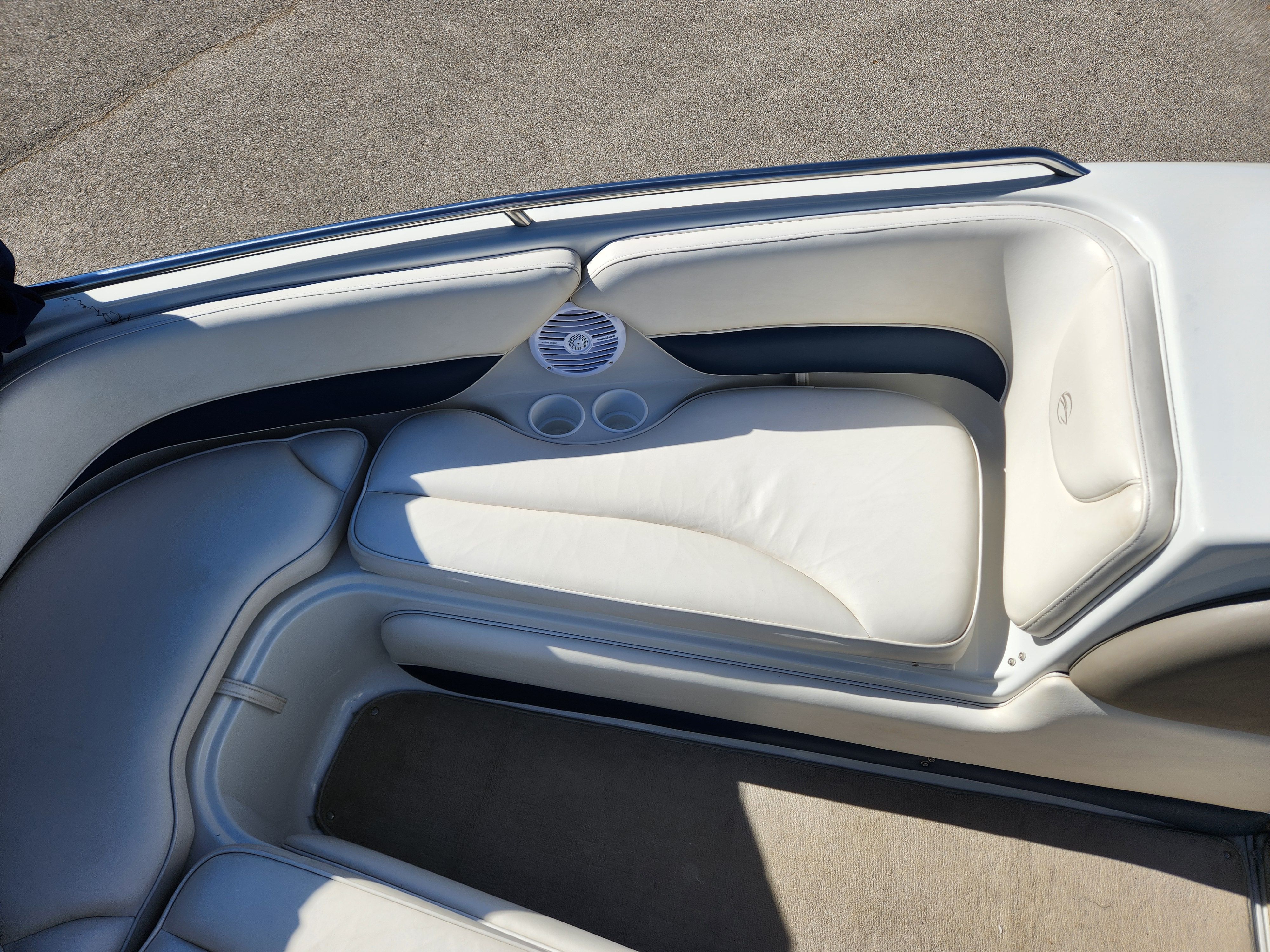 Interior of a 2003 Crownline 225 BR boat with white seating.