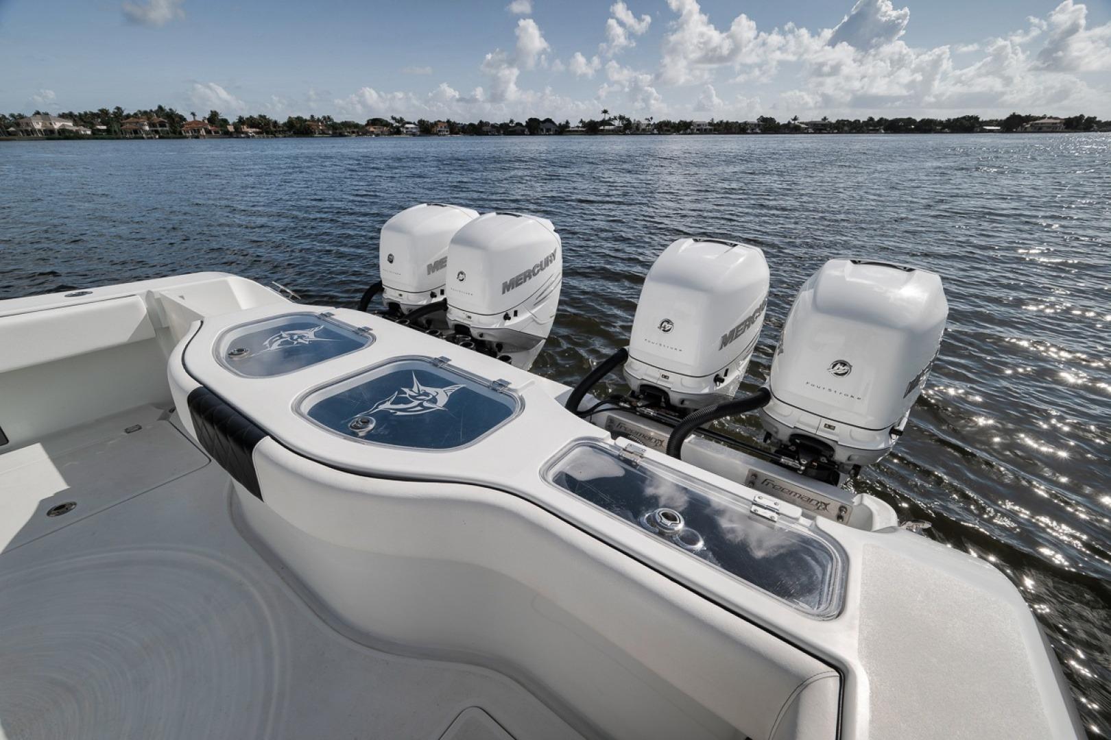 Freeman 42LR 2020 boat with four Mercury outboard engines on a calm lake.