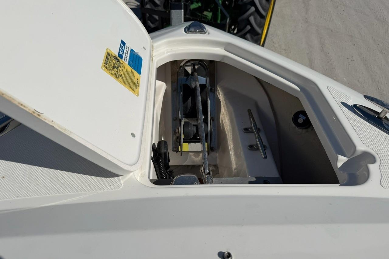 Open anchor locker on 2021 Pursuit DC 266 Dual Console boat, showing anchor mechanism.