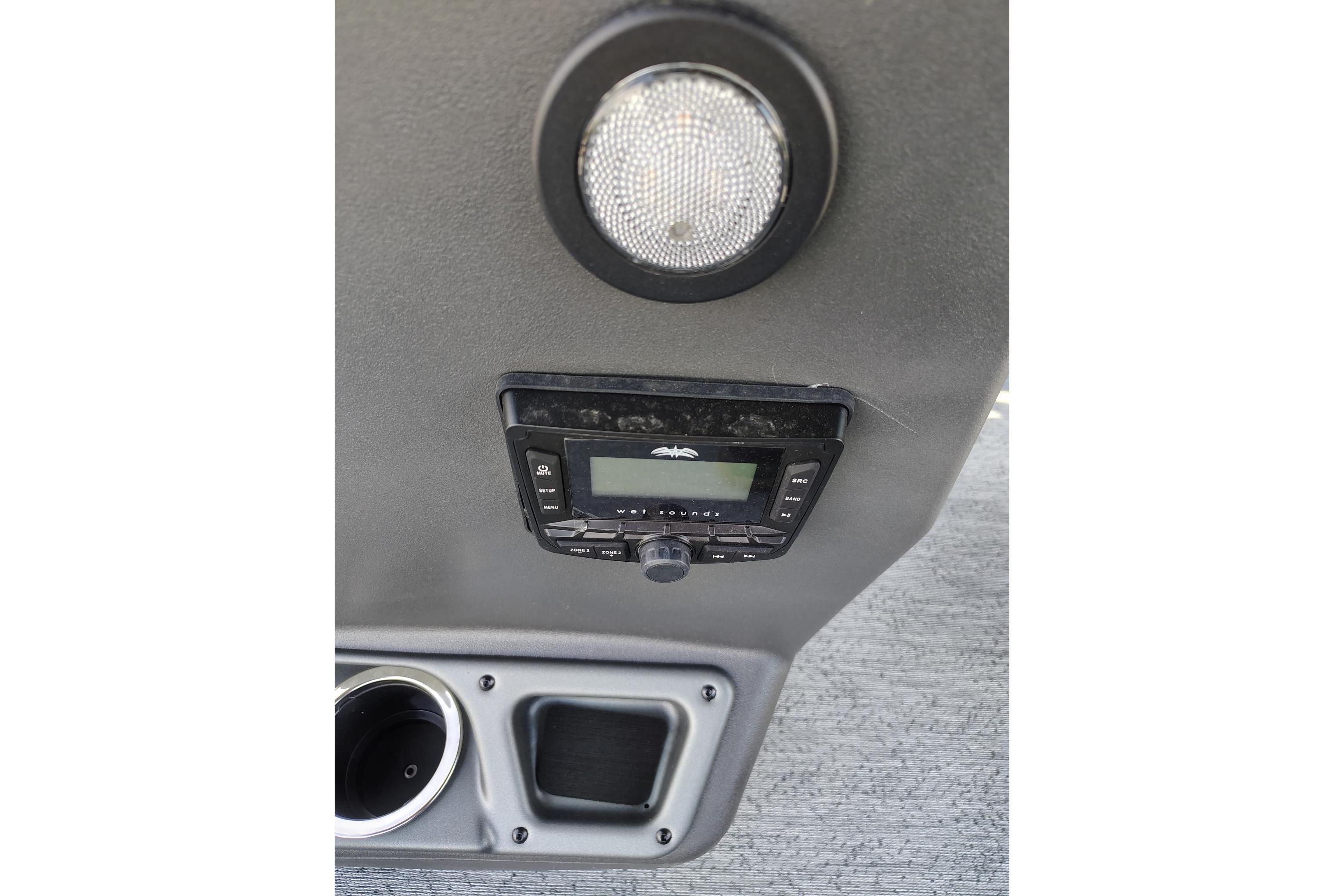 2026 Sun Tracker Bass Buggy 18 DLX interior with stereo system and cup holder.