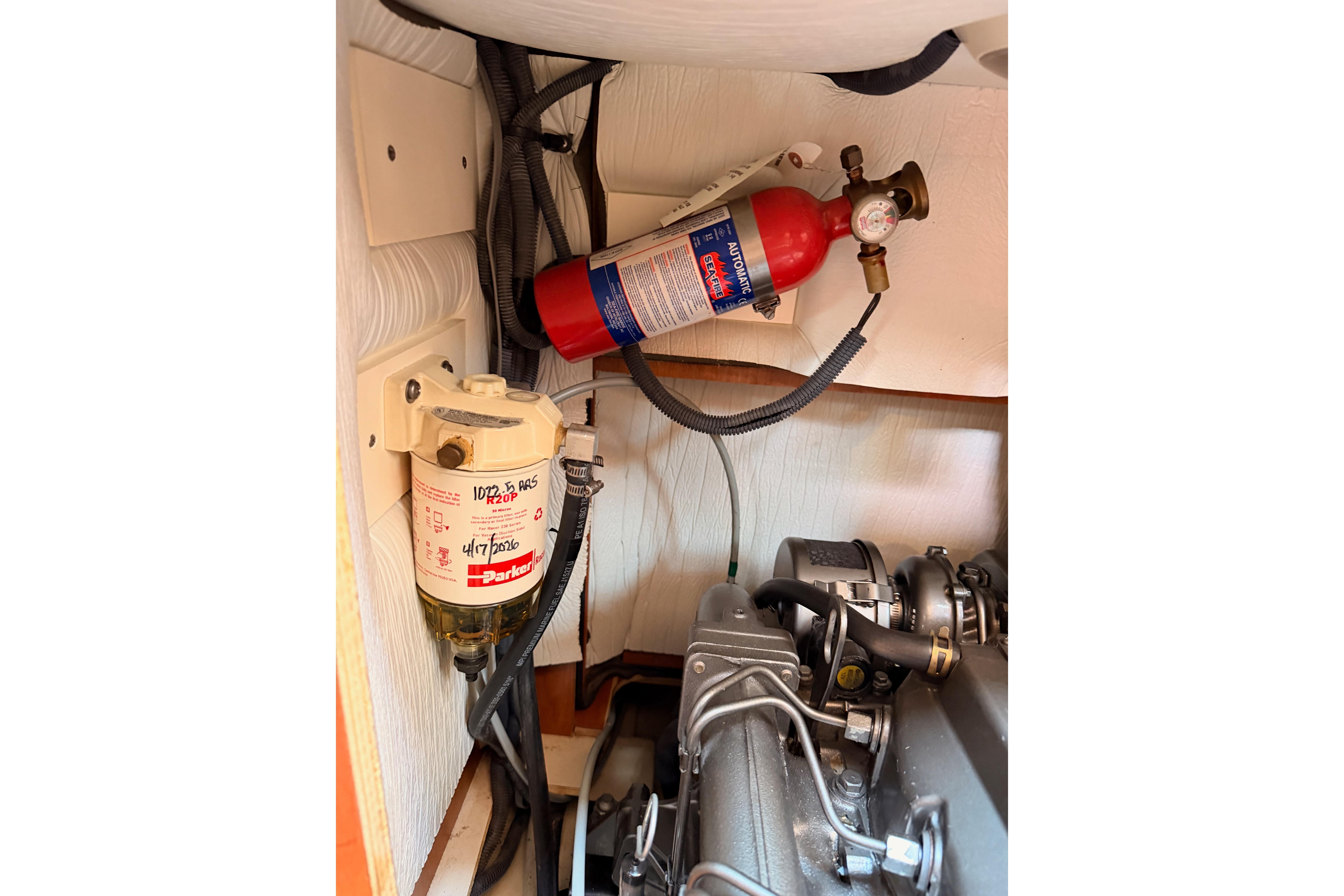 Engine compartment of 2008 Hunter 45 Deck Salon with fire extinguisher and fuel filter.