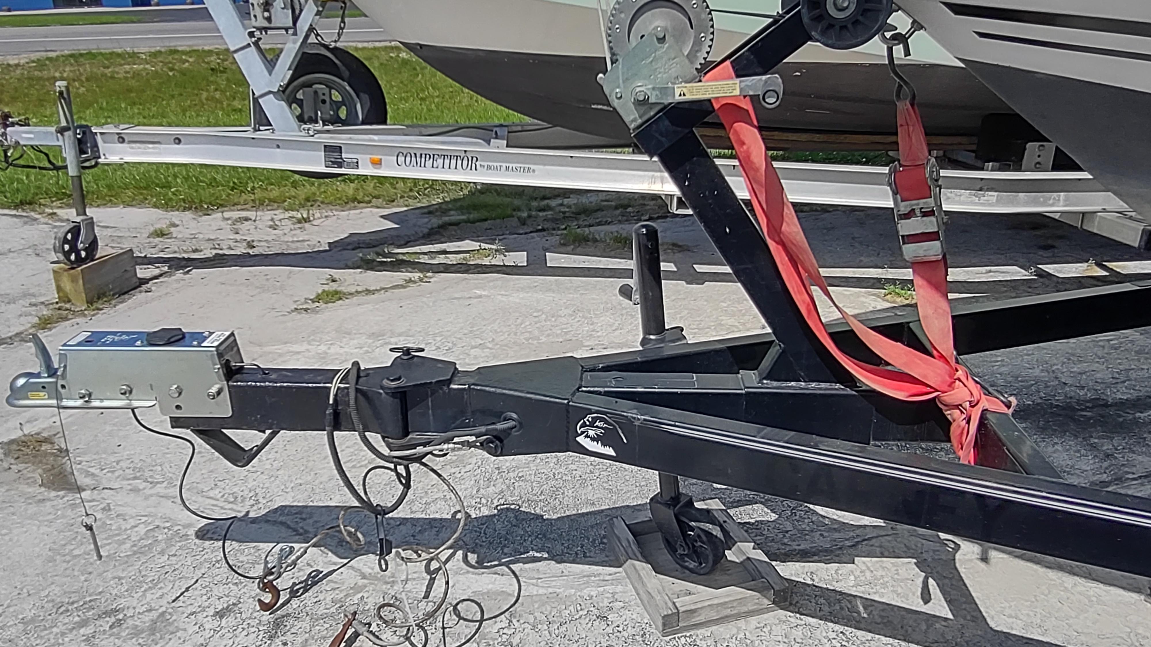 Trailer hitch of a 2001 Robalo 2020 Center Console boat, secured with red straps.