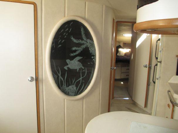 Interior of 1994 Sea Ray 500 Sundancer with oval marine-themed glass panel.