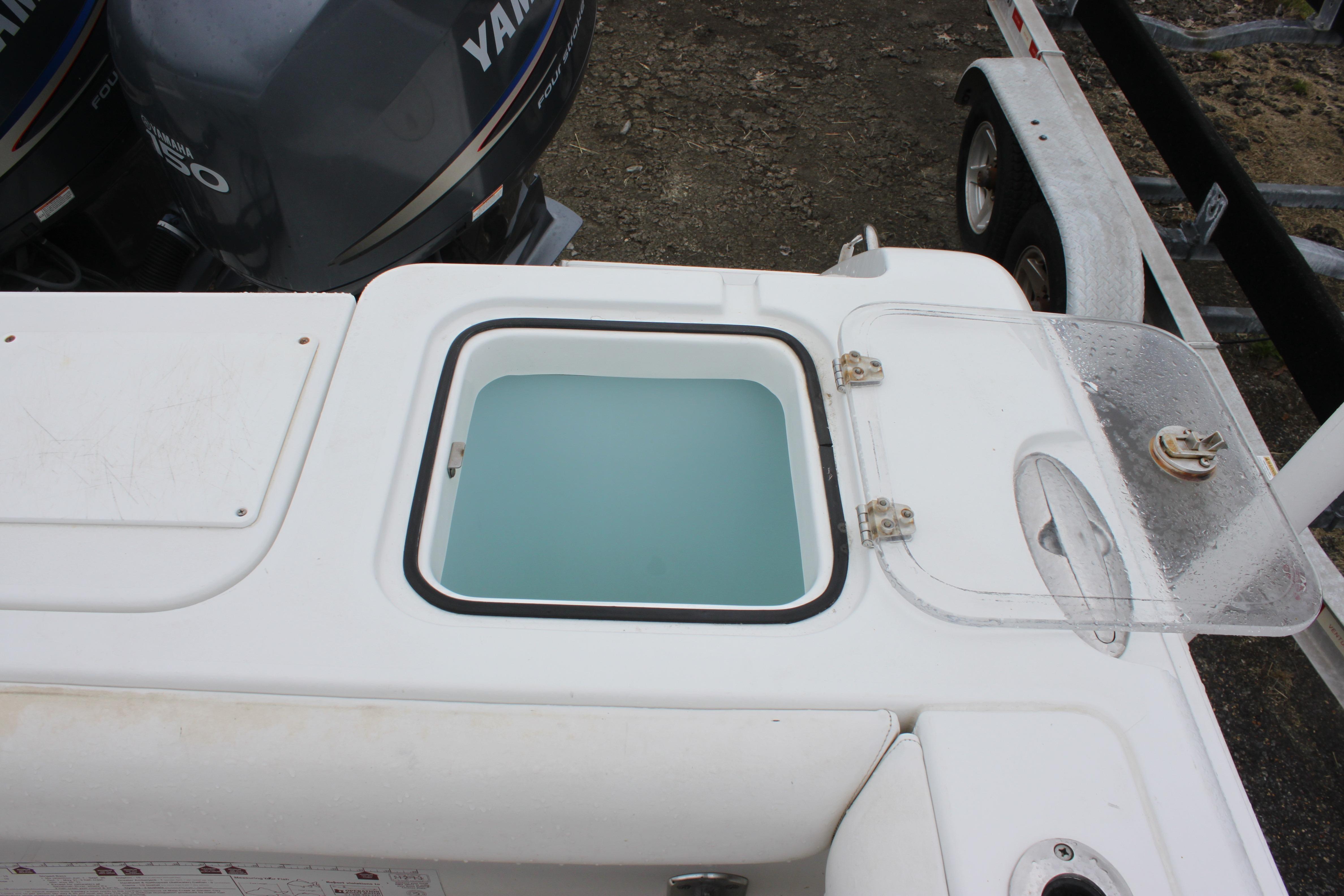 2012 Sea Hunt Gamefish 27 livewell with Yamaha outboard engines in view.
