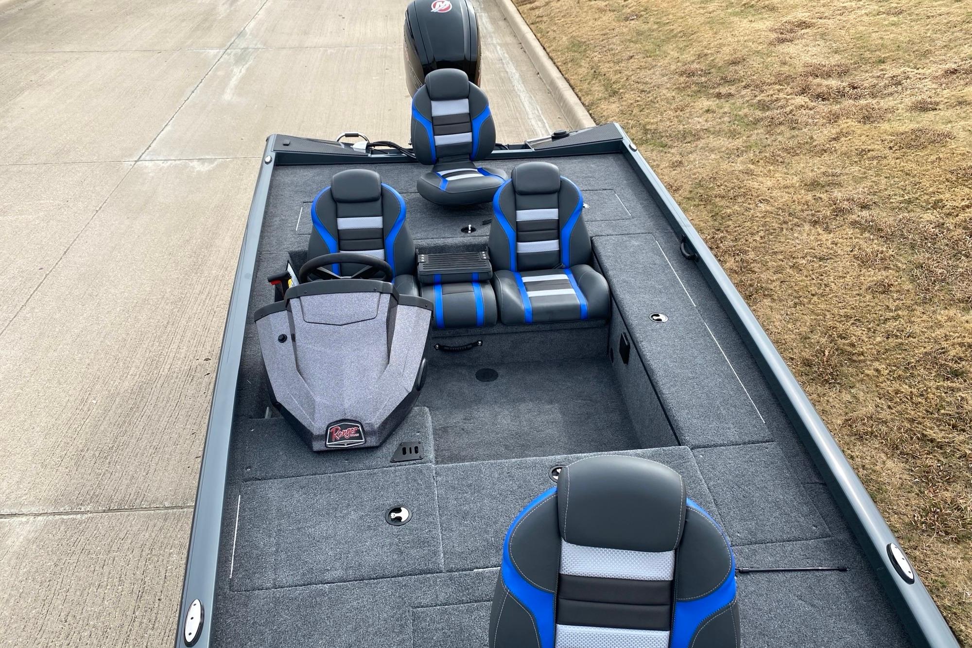 2026 Ranger RT188C boat interior with blue and gray seating on a concrete surface.