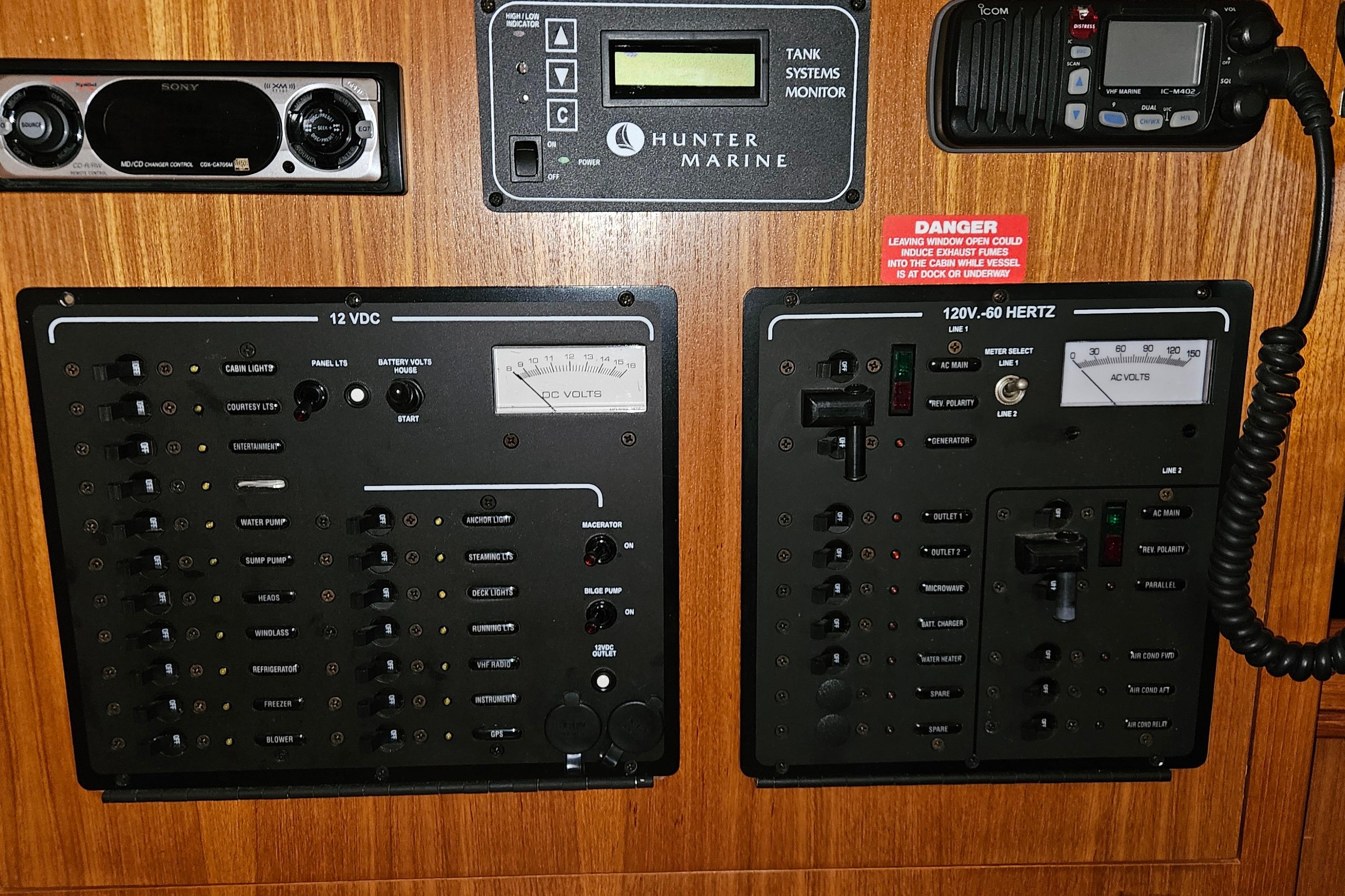 Electrical control panel on a 2004 Hunter 386 sailboat, featuring various switches and meters.
