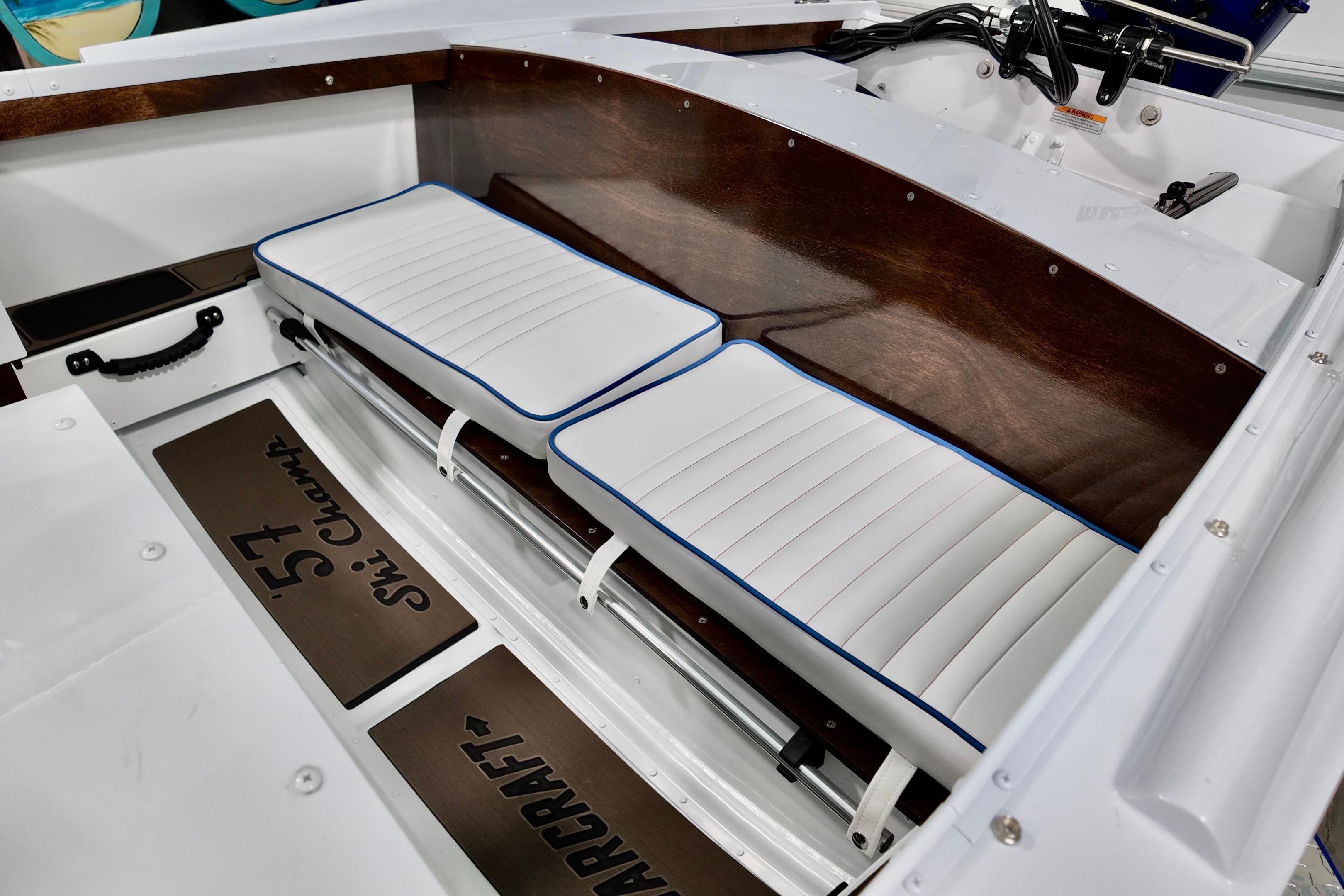 Interior of 2026 Starcraft 57 Ski Champ boat with white cushioned seats.