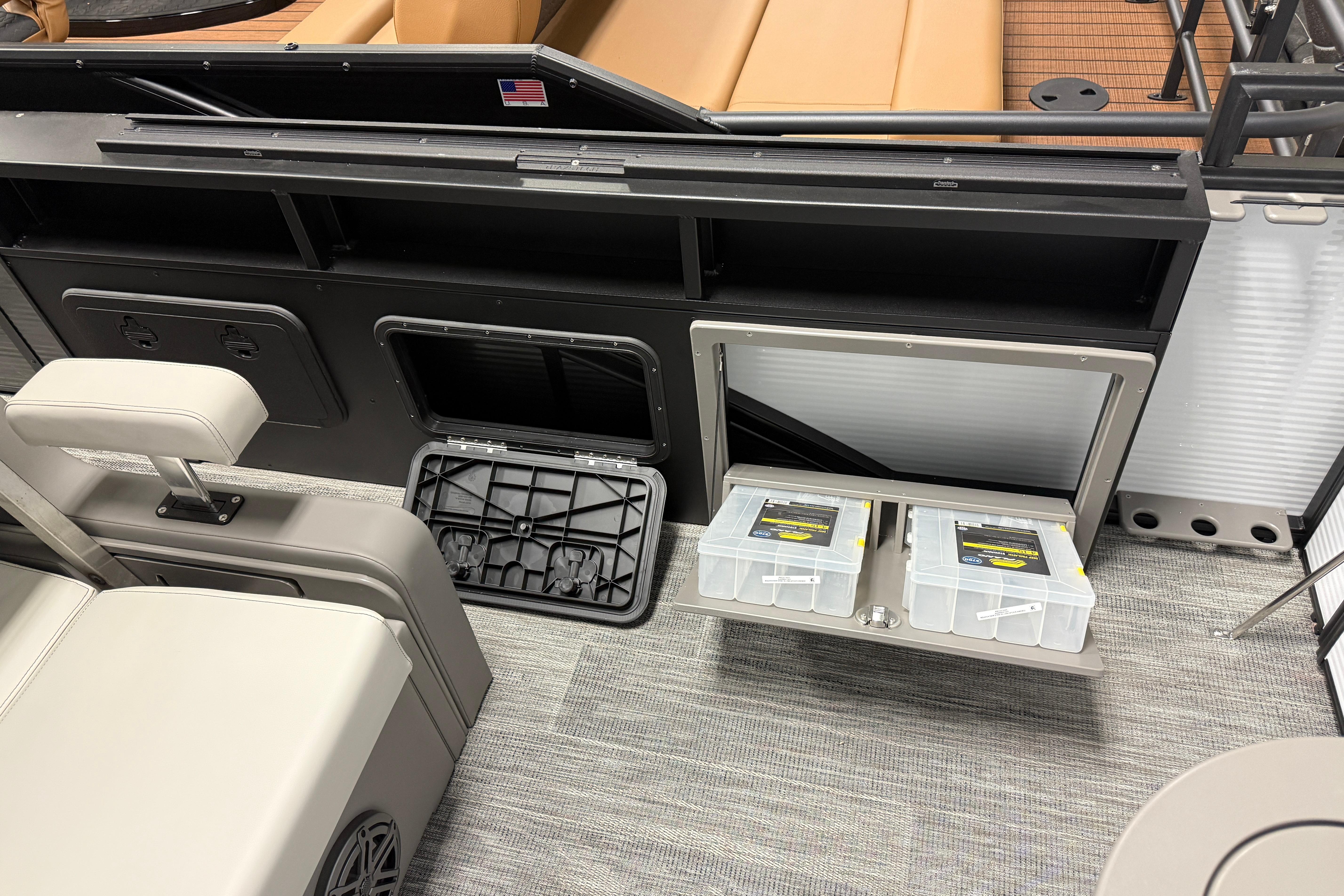 2026 Qwest M-Class 22 Pro Sport boat interior with storage compartments and seating.