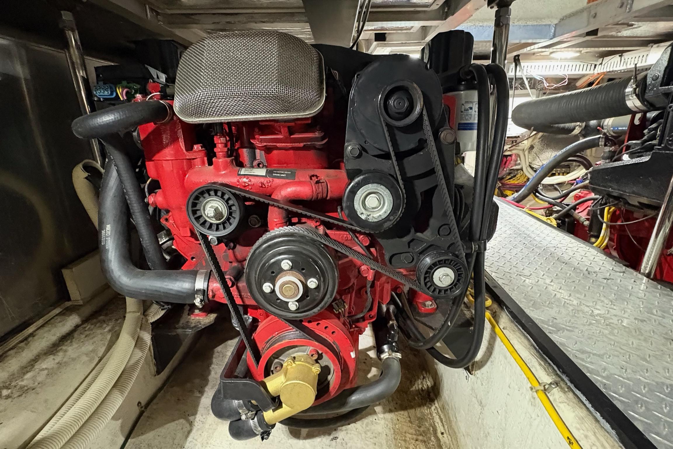 Engine room of 2003 Carver 396 Motor Yacht, featuring a red marine engine.