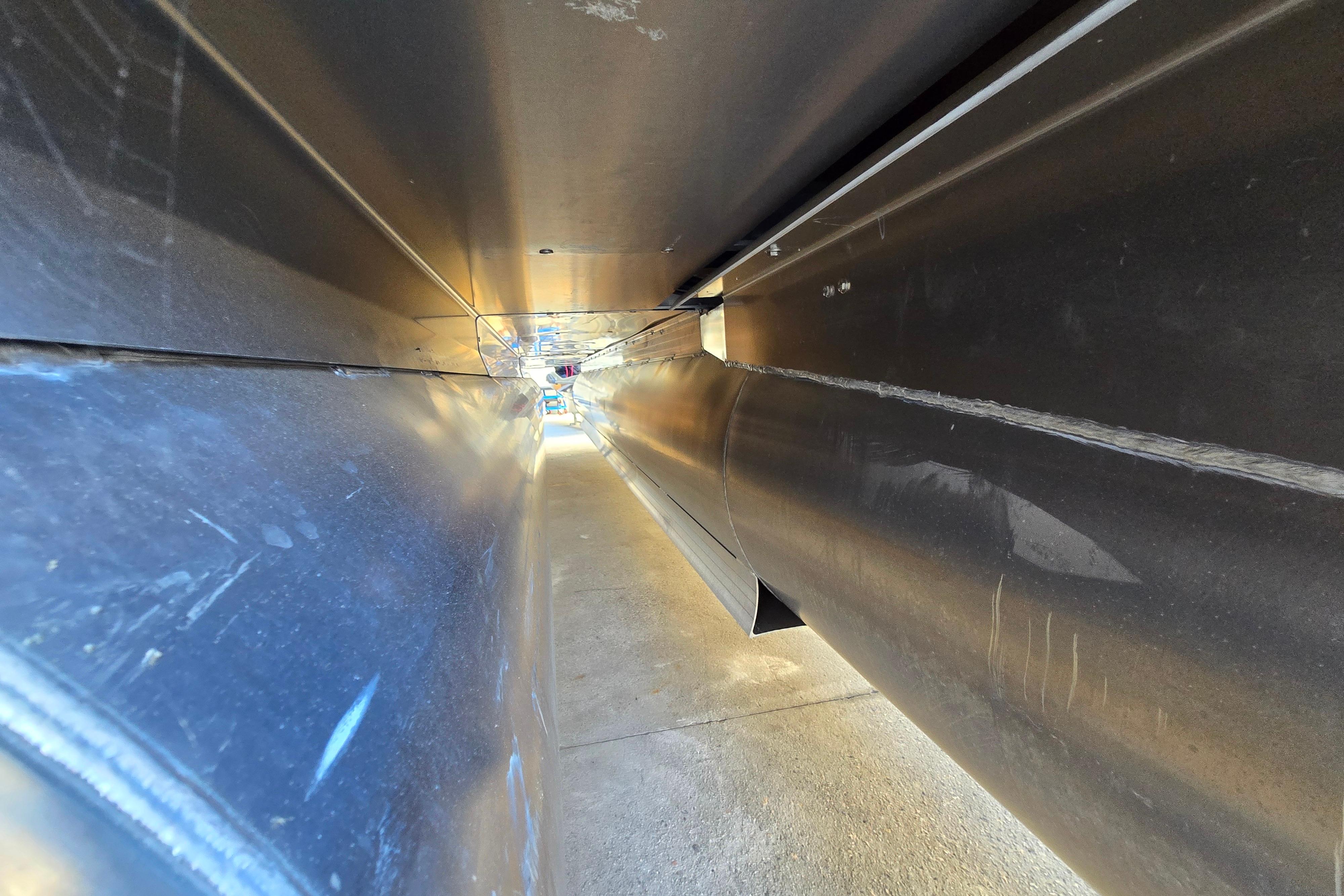 Underneath view of 2024 Godfrey Sweetwater 2486 SB pontoon boat, showcasing structural details.