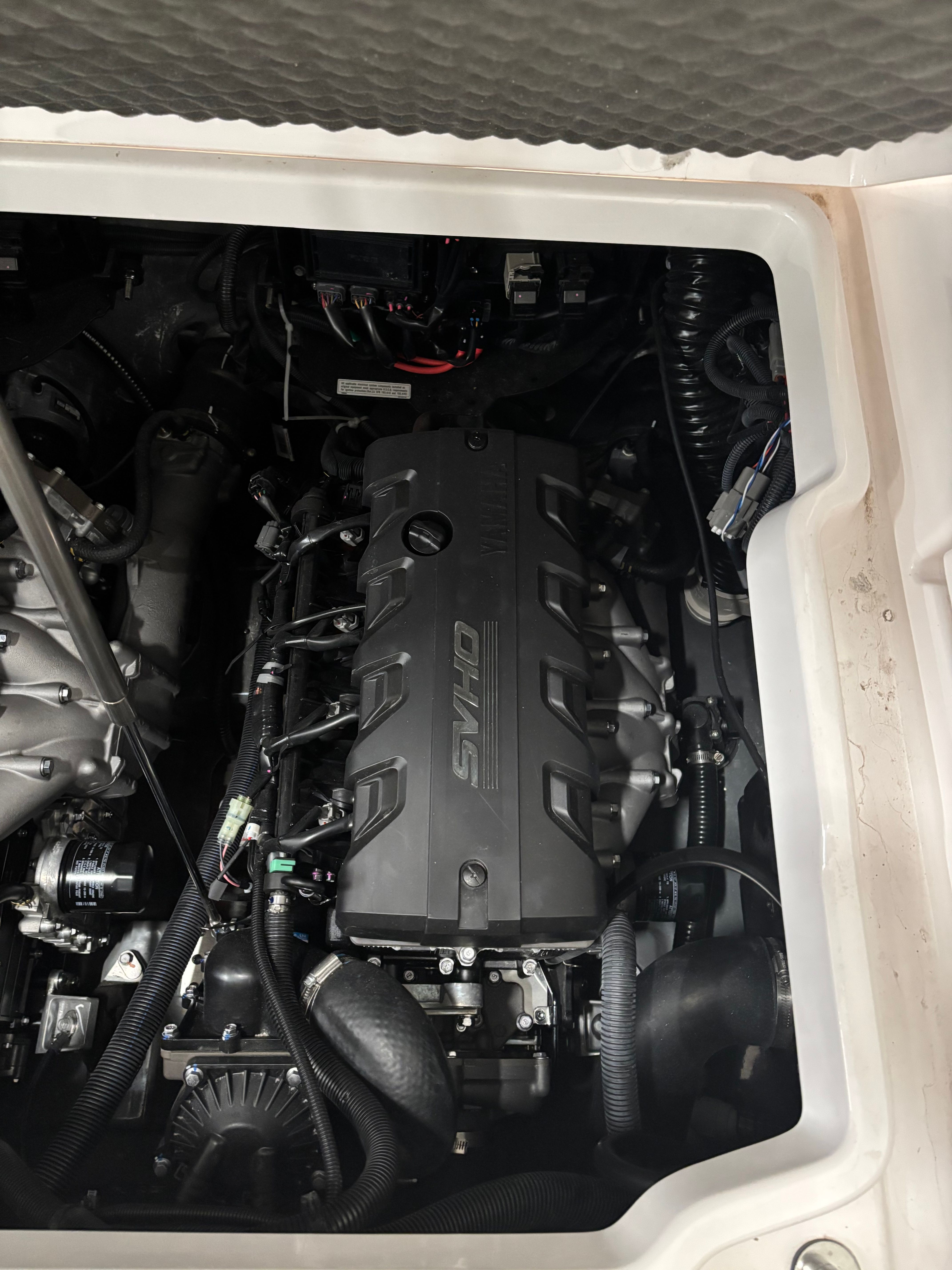 Engine compartment of a Yamaha 222 FSH Sport E boat with a powerful engine.