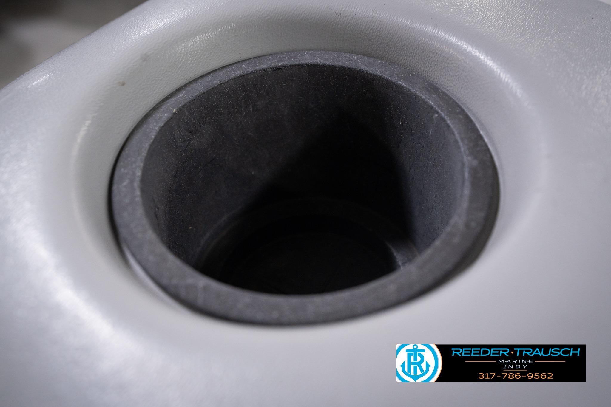 Close-up of a 1992 Godfrey Sweetwater boat cup holder, featuring Reeder Trausch Marine logo.