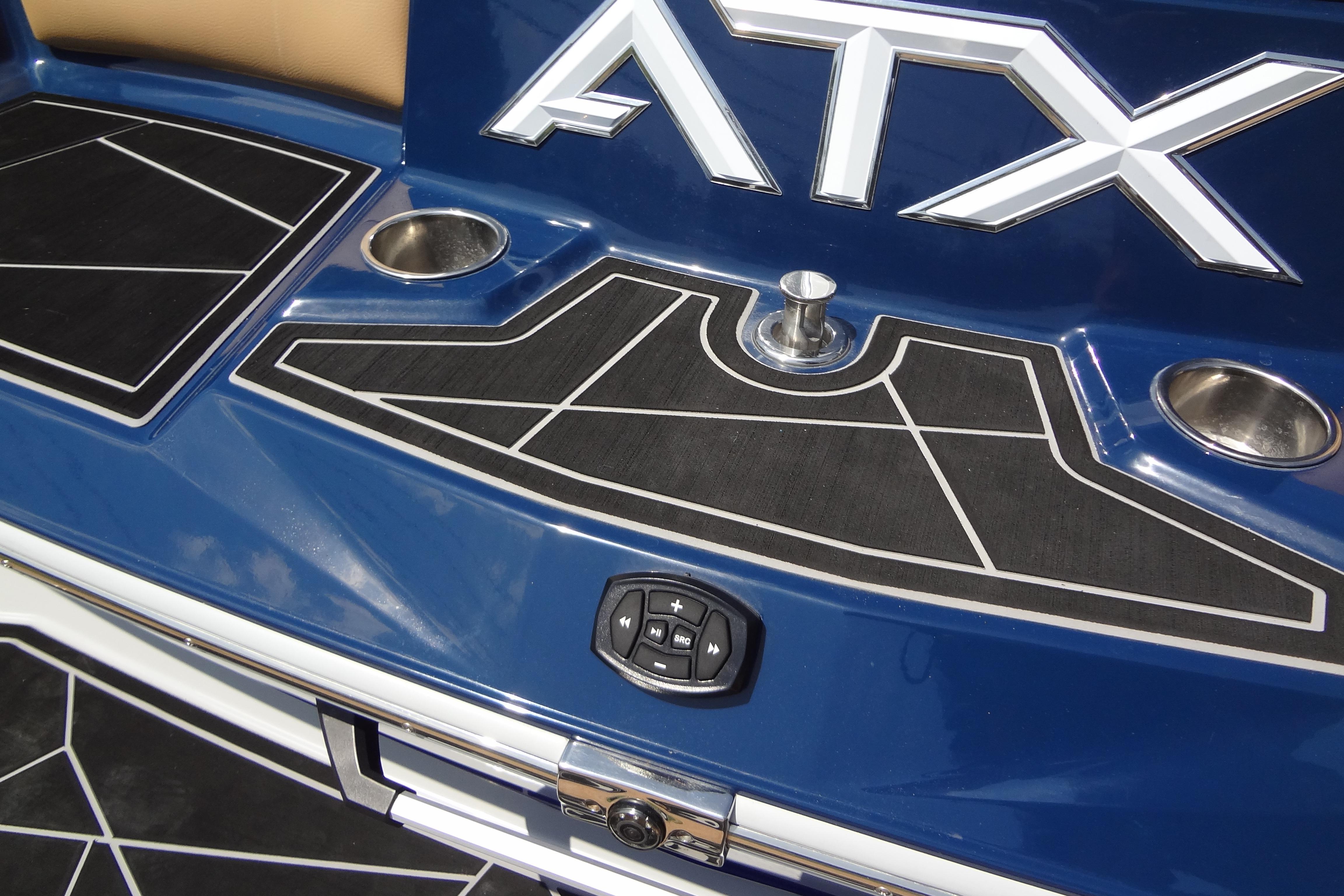 2022 ATX Surf Boats 24 Type-S, blue deck with cup holders and control panel.