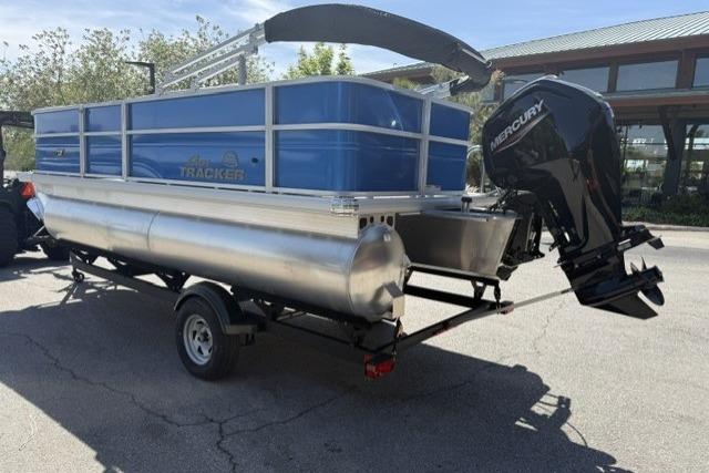 2026 Sun Tracker Party Barge 18 DLX pontoon boat on trailer, featuring Mercury outboard motor.