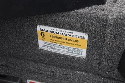 2026 Lowe Fishing Machine 1675 WT capacity label, 6 persons or 854 lbs limit.