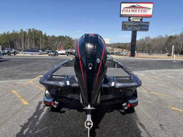2025 Phoenix 920 Elite boat with powerful engine, parked outdoors at dealership.