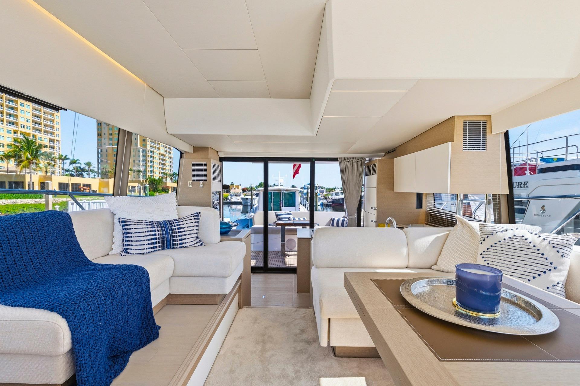 Luxurious interior of a 2022 Prestige 520 yacht with elegant seating and decor.