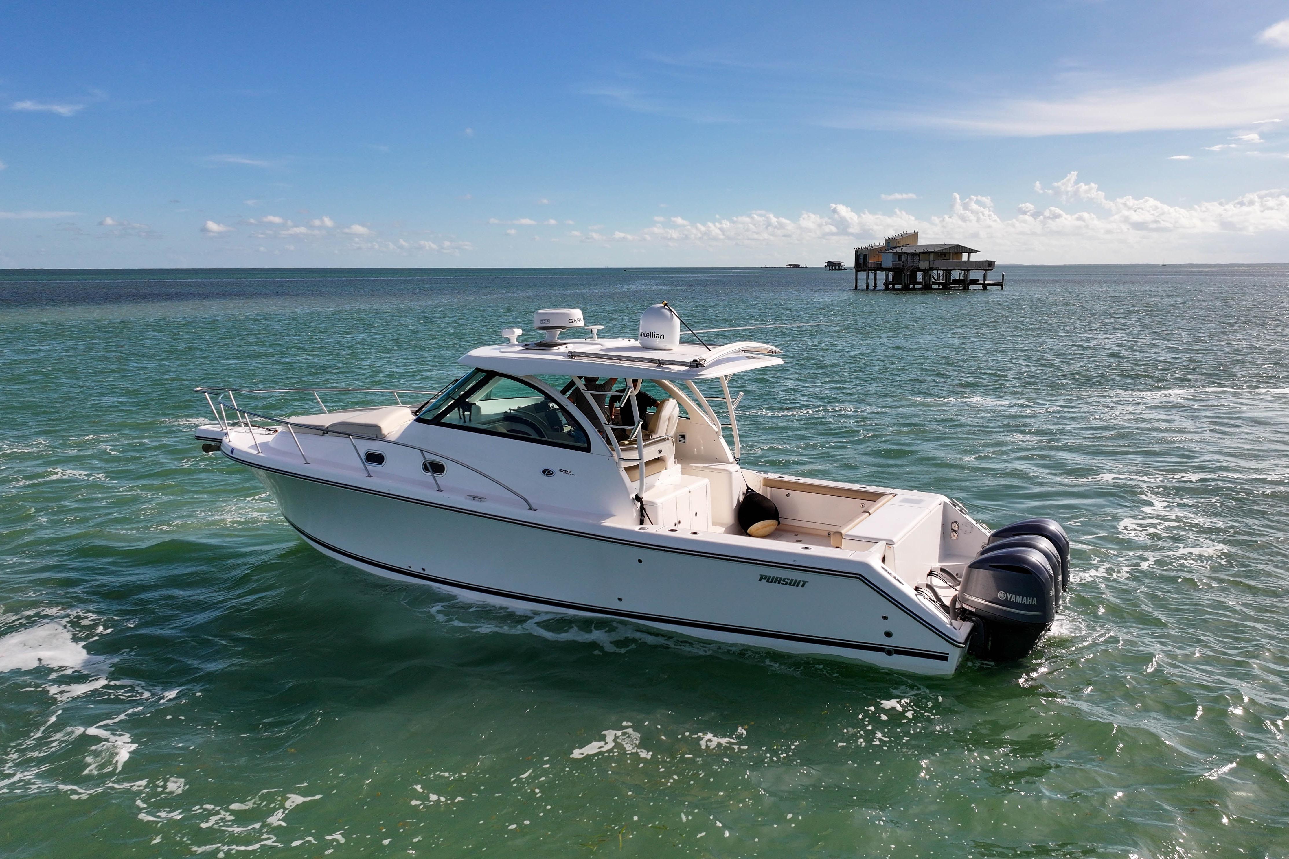 2016 Pursuit OS 385 Offshore boat cruising on open water under clear skies.