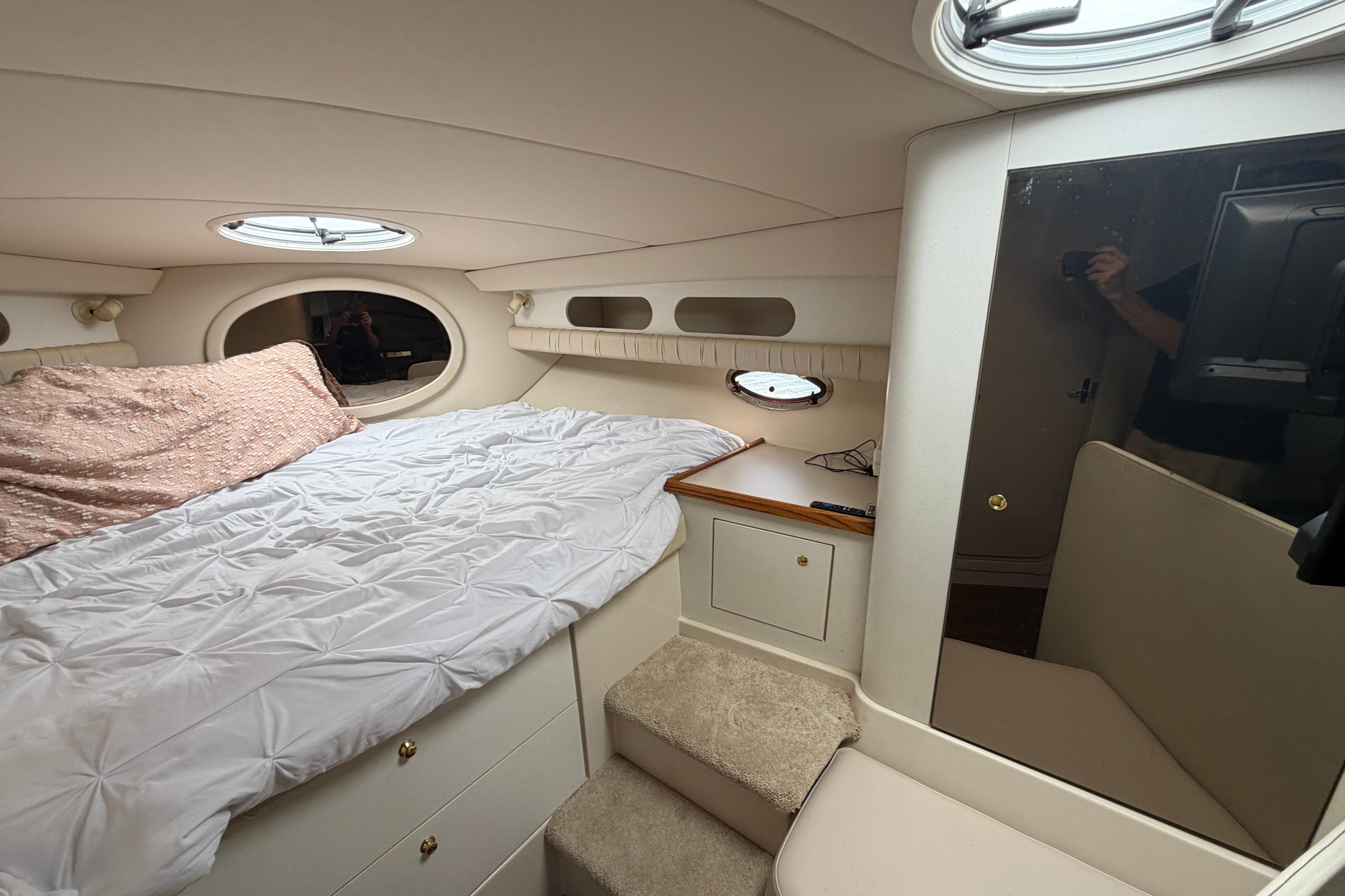 Interior cabin of a 1997 Cruisers 3575 yacht with bed and storage.