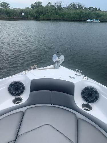 Bow view of 2020 Rinker 29QX BR boat on calm water.